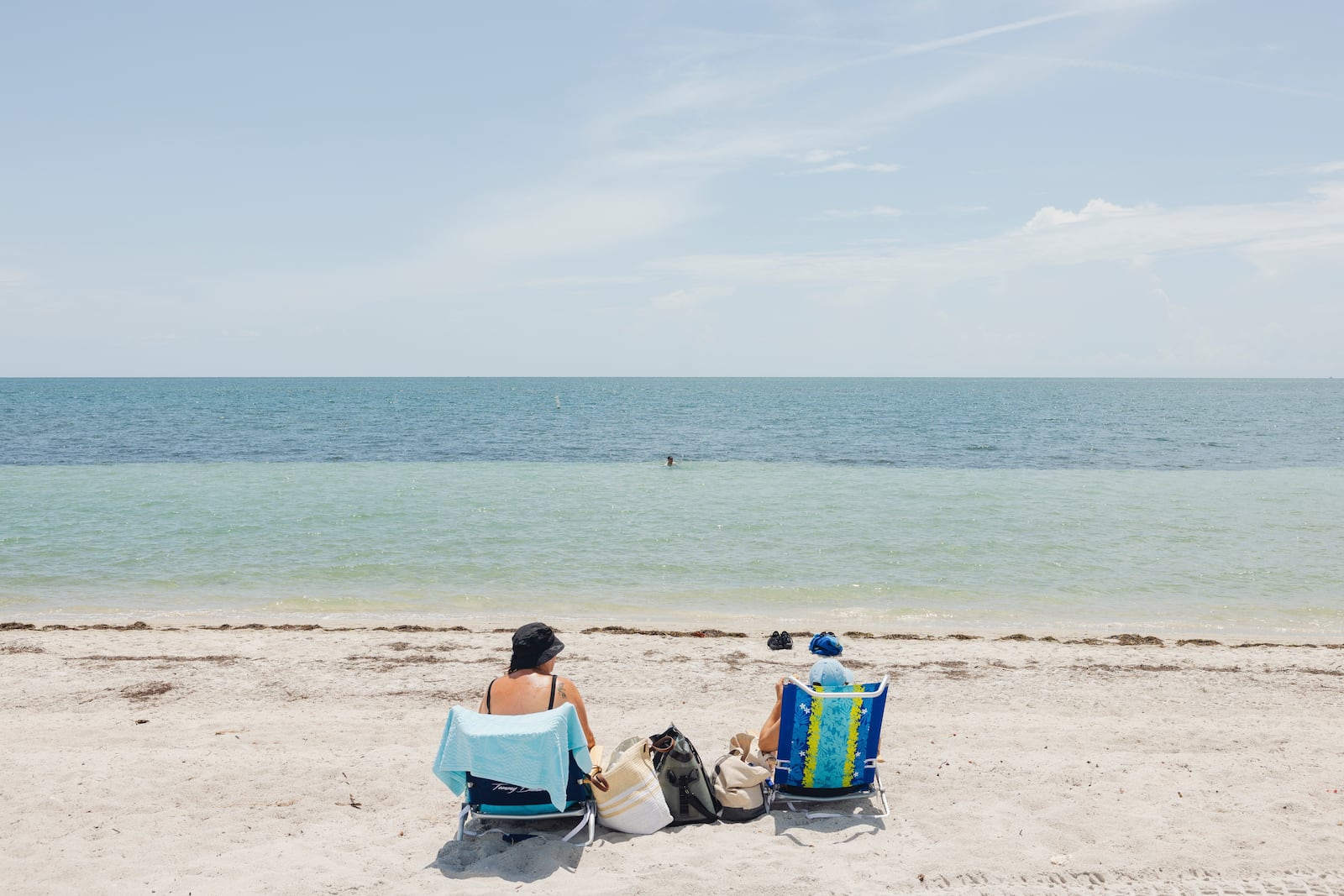 A family enjoys time at Key Biscayne Beach in Florida on July 18, 2023. (Alfonso Duran/The New York Times)
                      