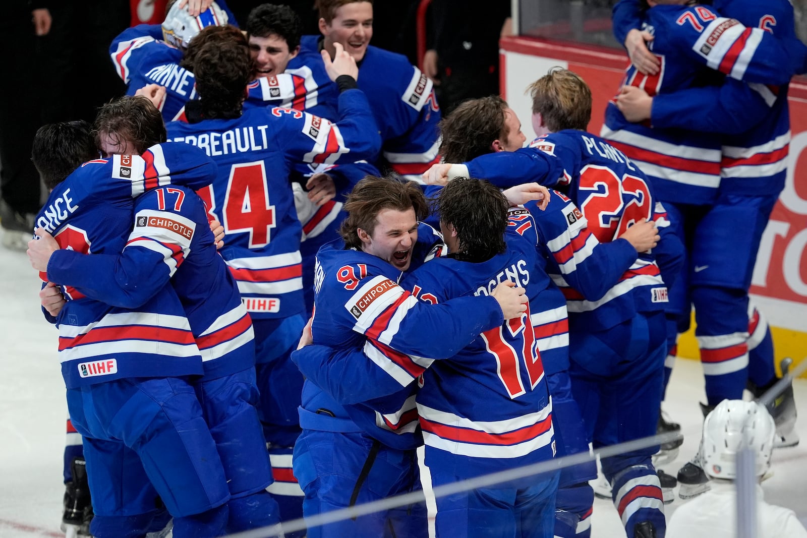 United States players celebrate after their overtime win over Finland in IIHF World Junior Hockey Championship gold medal game action in Ottawa, Ontario, Sunday, Jan. 5, 2025. (Adrian Wyld/The Canadian Press via AP)