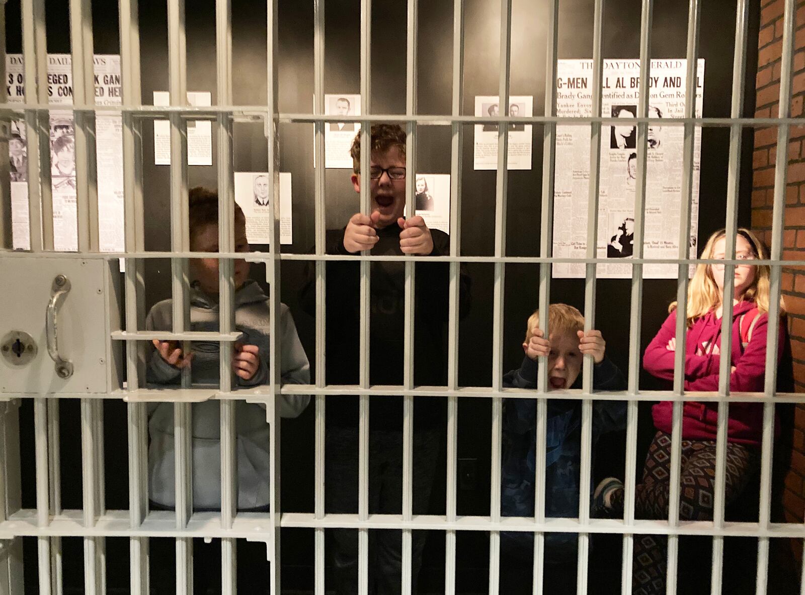 Steve Grismer’s grandchildren explore the jail cell on opening night. Contributed