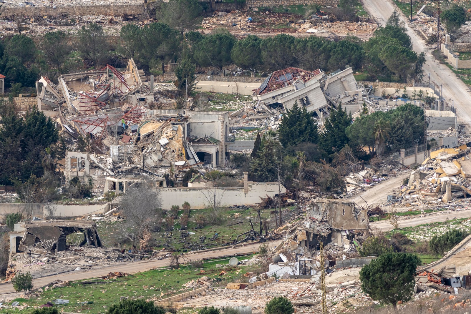 Destroyed buildings in southern Lebanon, as seen from northern Israel, Sunday, Jan. 26, 2025. (AP Photo/Ariel Schalit)