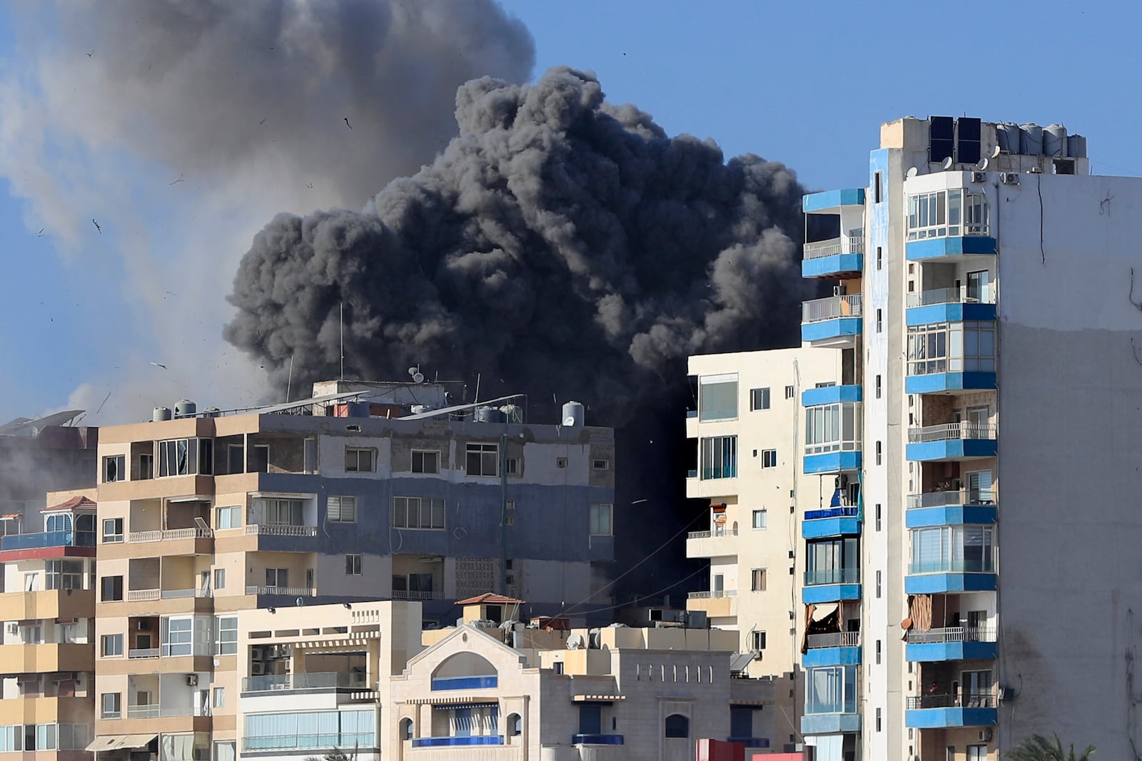 Smoke rises from buildings hit by Israeli airstrikes in Tyre, southern Lebanon, Monday, Oct. 28, 2024. (AP Photo/Mohammad Zaatari)