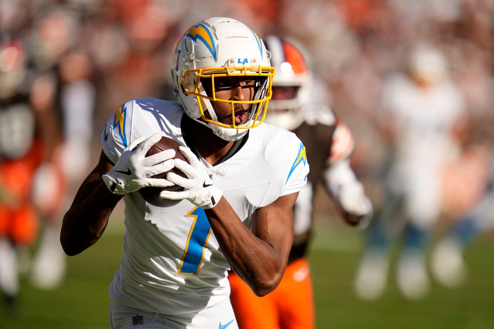 Los Angeles Chargers wide receiver Quentin Johnston (1) scores a touchdown on a 66-yard reception against the Cleveland Browns in the first half of an NFL football game Sunday, Nov. 3, 2024, in Cleveland. (AP Photo/Sue Ogrocki)