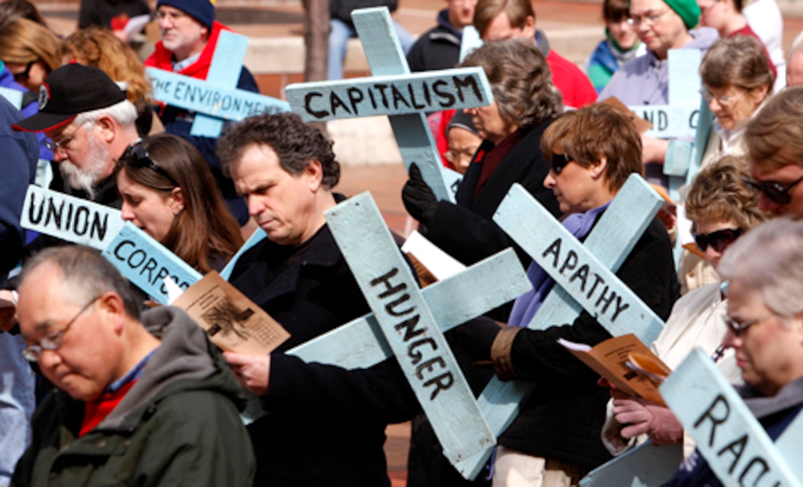 A Walk for Justice and Peace is held annually on Good Friday in downtown Dayton. Participants stop at various locations for the traditional stations of the cross Jesus walked to bring awareness to social issues. FILE