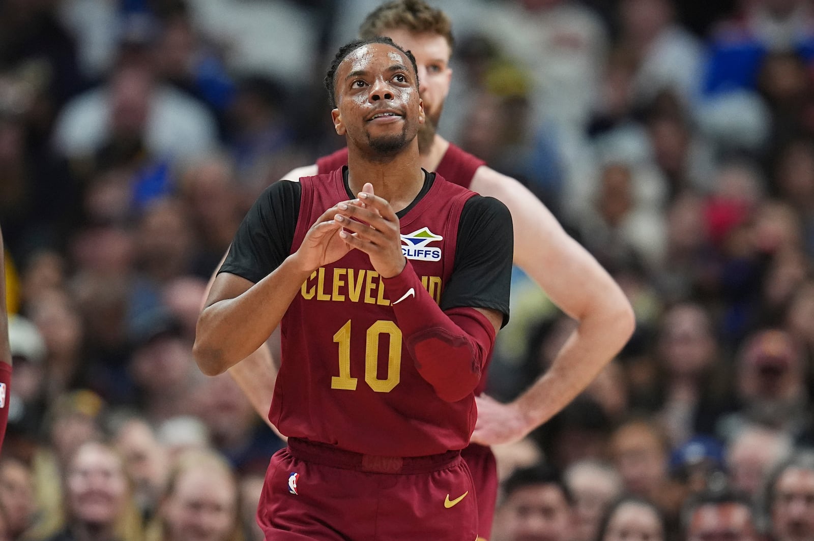 Cleveland Cavaliers guard Darius Garland reacts after scoring a basket against the Denver Nuggets in the first half of an NBA basketball game Friday, Dec. 27, 2024, in Denver. (AP Photo/David Zalubowski)