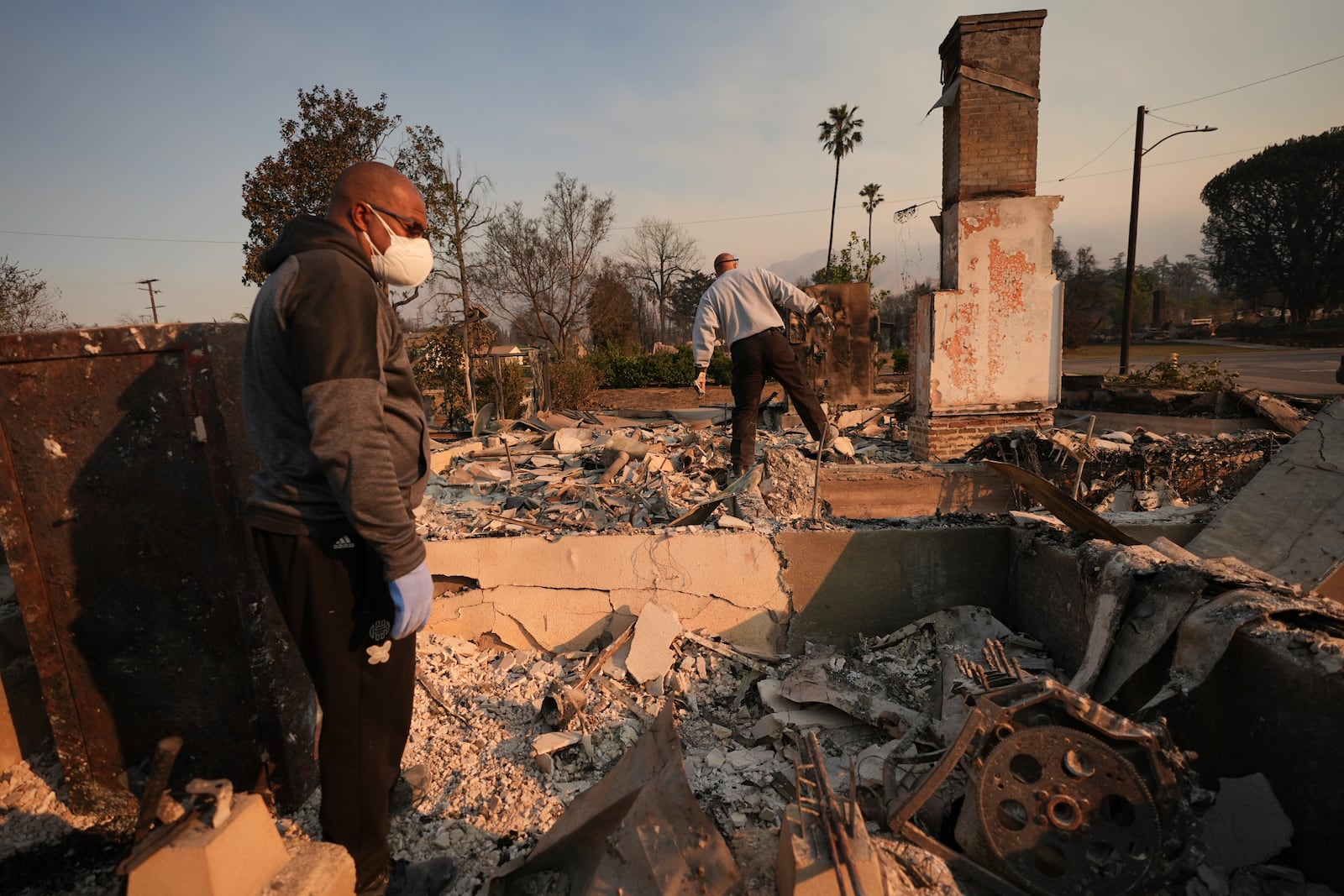 FILE - Kenneth Snowden, left, surveys the damage to his fire-ravaged property with his brother Ronnie in the aftermath of the Eaton Fire, Jan. 10, 2025, in Altadena, Calif. (AP Photo/Jae C. Hong, File)