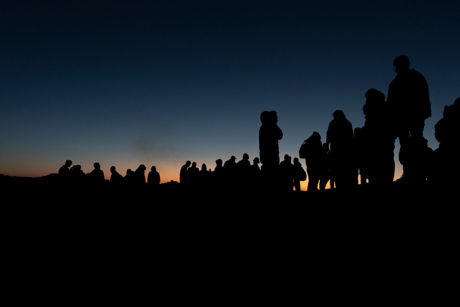 FILE - Chinese migrants wait to be processed after crossing the border with Mexico May 8, 2024, near Jacumba Hot Springs, Calif. (AP Photo/Ryan Sun, File)