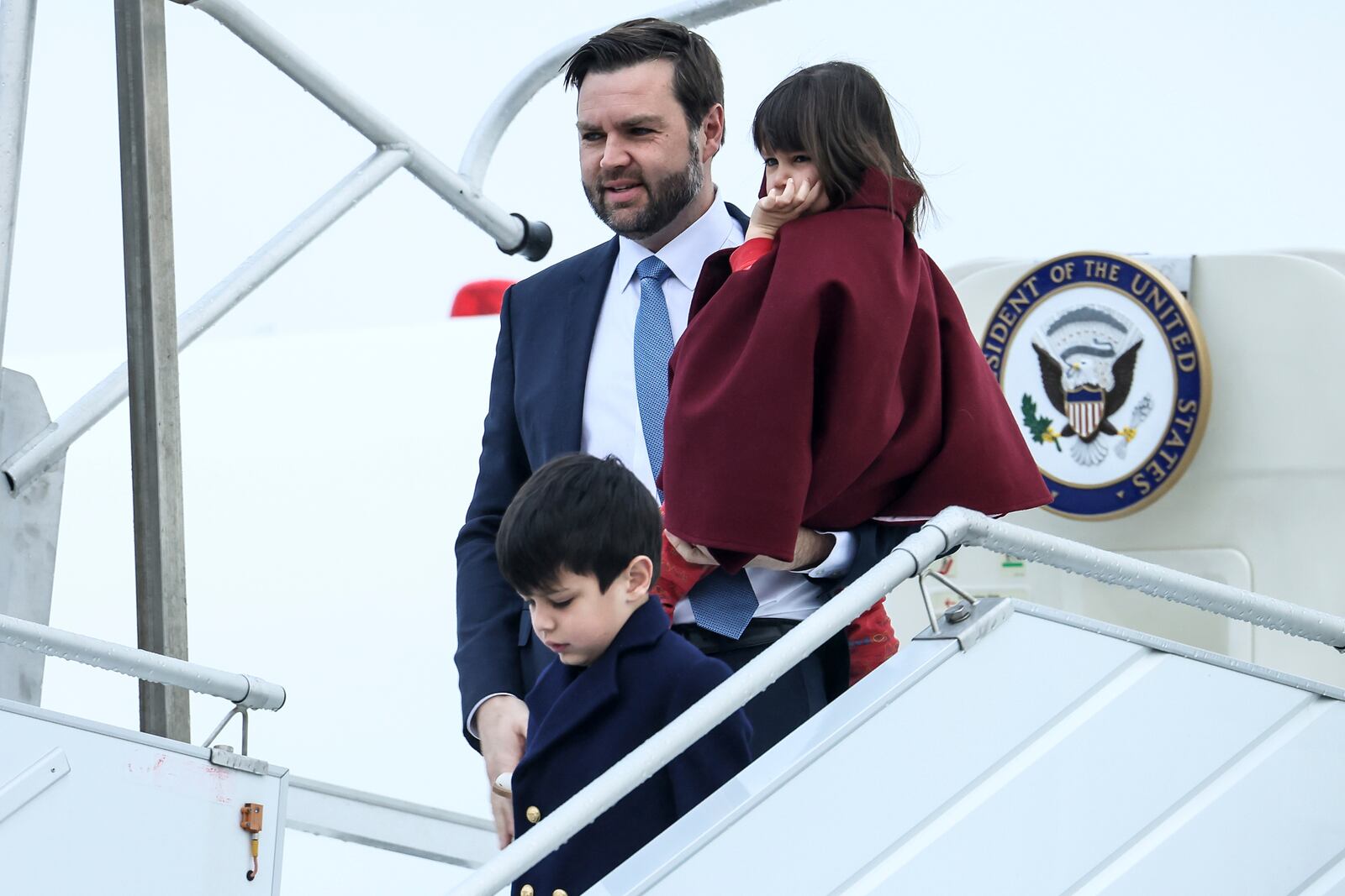 United States Vice-President JD Vance, center, carries his daughter Mirabel as he arrives at Paris Orly Airport, ahead of an Artificial Intelligence Action Summit taking place in Paris, Monday, Feb. 10, 2025. (AP Photo/Thomas Padilla)