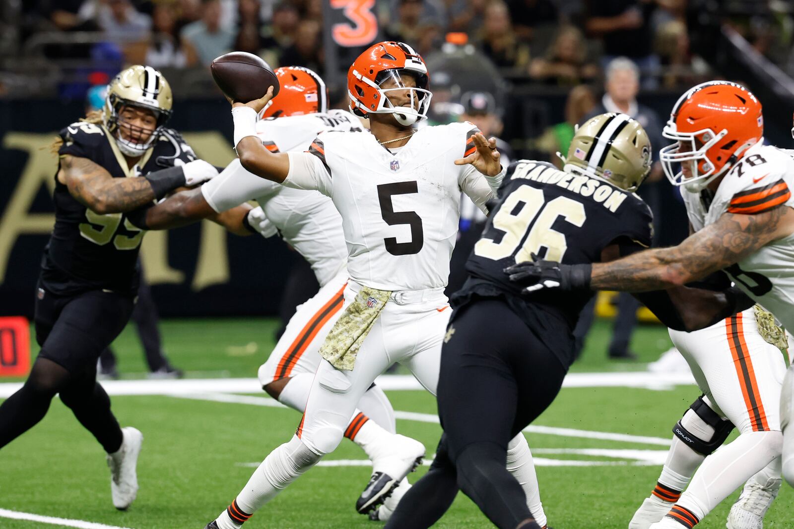 Cleveland Browns quarterback Jameis Winston (5) passes under pressure in the first half of an NFL football game against the New Orleans Saints in New Orleans, Sunday, Nov. 17, 2024. (AP Photo/Butch Dill)