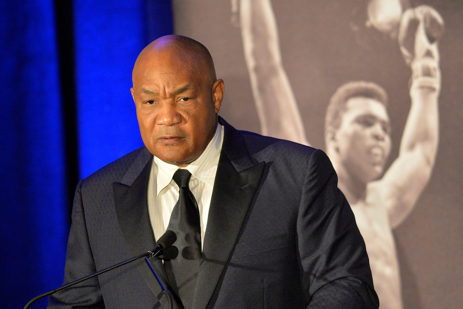 FILE -Former heavyweight boxing champion George Foreman gives a stern look to Muhammad Ali during the Sports Illustrated Legacy Awards Thursday, Oct. 1, 2015, in Louisville, Ky. (AP Photo/Timothy D. Easley, File)