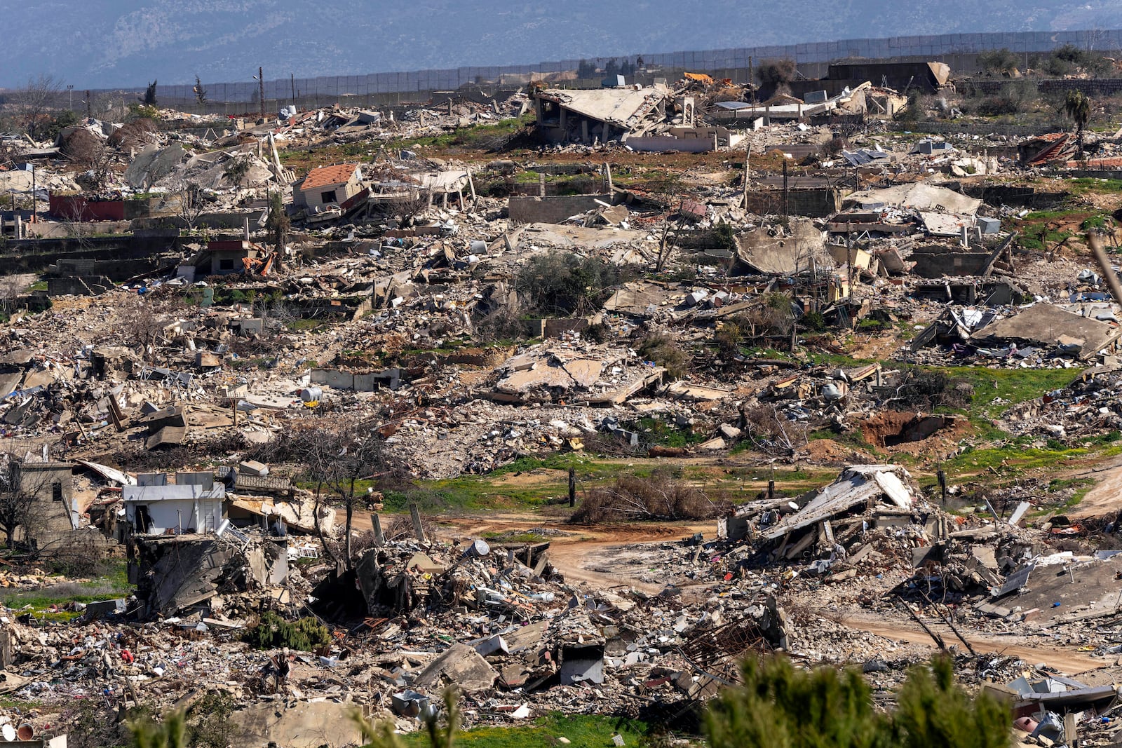 Destroyed houses caused by the Israeli air and ground offensive, in the town of Kfar Kila, southern Lebanon, Tuesday, Feb. 18, 2025. (AP Photo/Hassan Ammar)