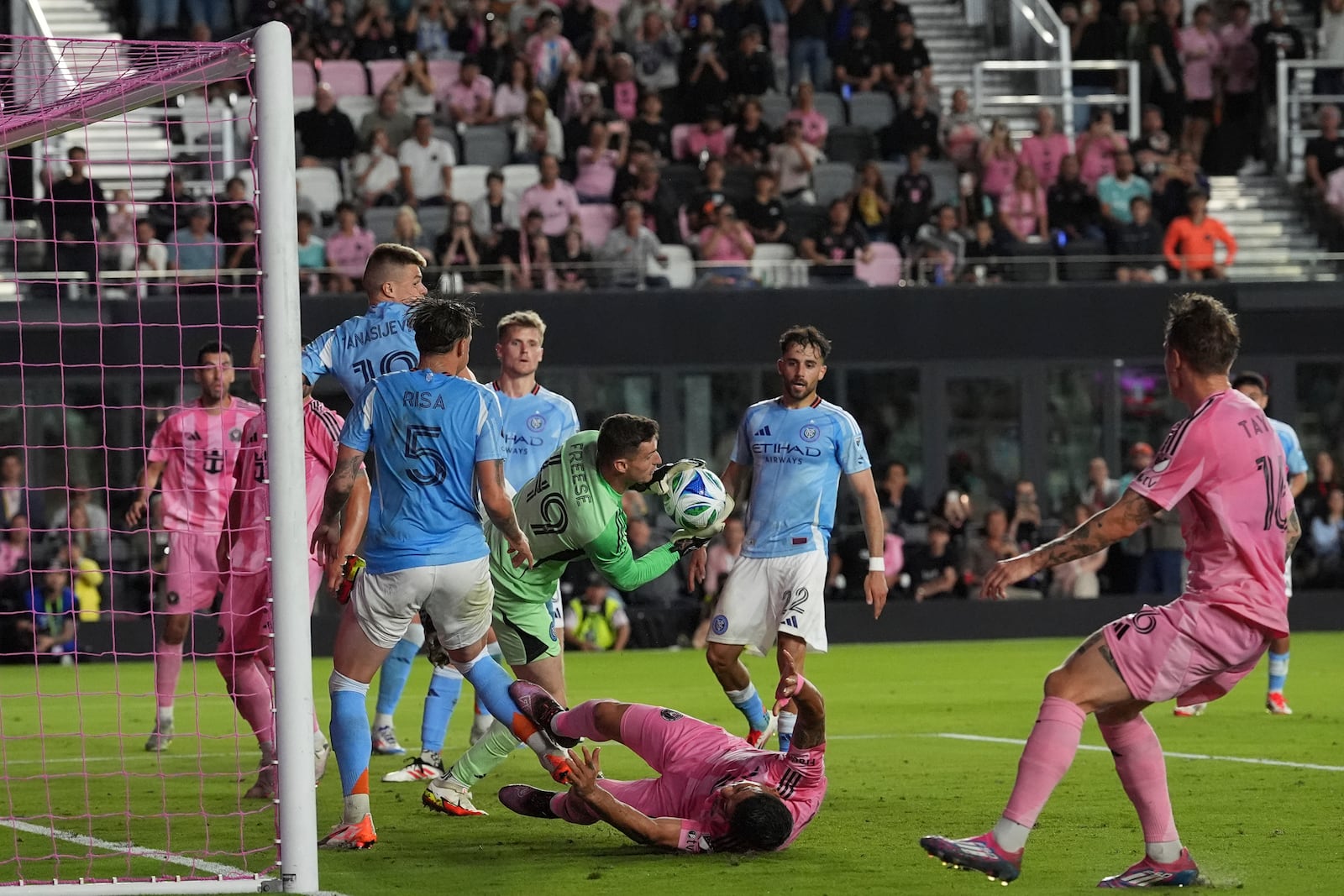 New York City FC goalkeeper Matt Freese (49) snags the ball as Inter Miami forward Luis Suarez hits the ground during the first half of an MLS soccer match, Saturday, Feb. 22, 2025, in Fort Lauderdale, Fla. (AP Photo/Rebecca Blackwell)