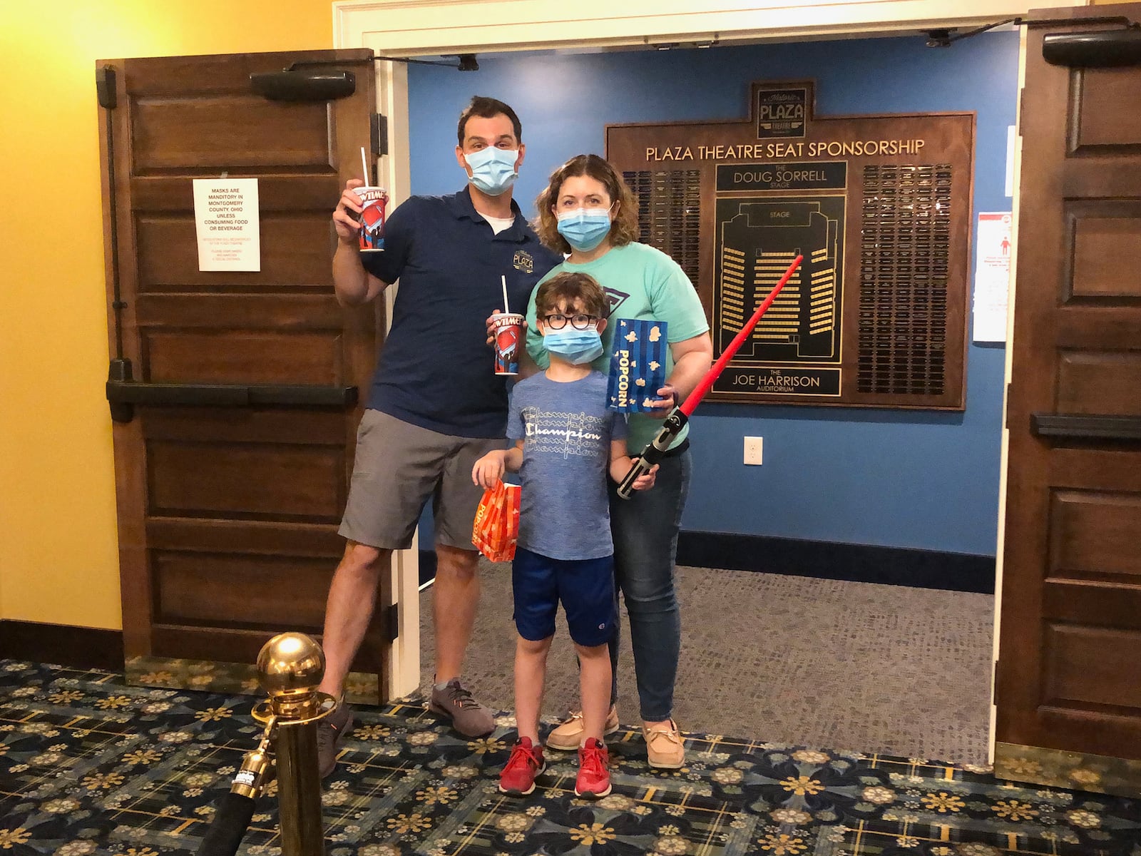 A family visits the Plaza Theatre for a showing of "Star Wars," which was released by Walt Disney Studios for special showings in theaters this summer. Shown are Chris, Melissa and (front) Gideon Sedlak. CONTRIBUTED