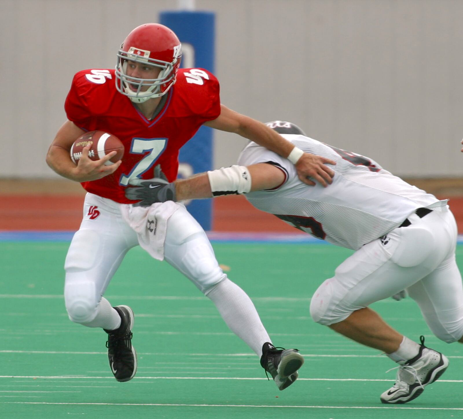 10-2-04 -- University of Dayton's quarterback Brandon Staley moves the ball for the Flyers as the Davidson defense moves in during second quarter action at Welcome Stadium. Ty Greenlees/DDN