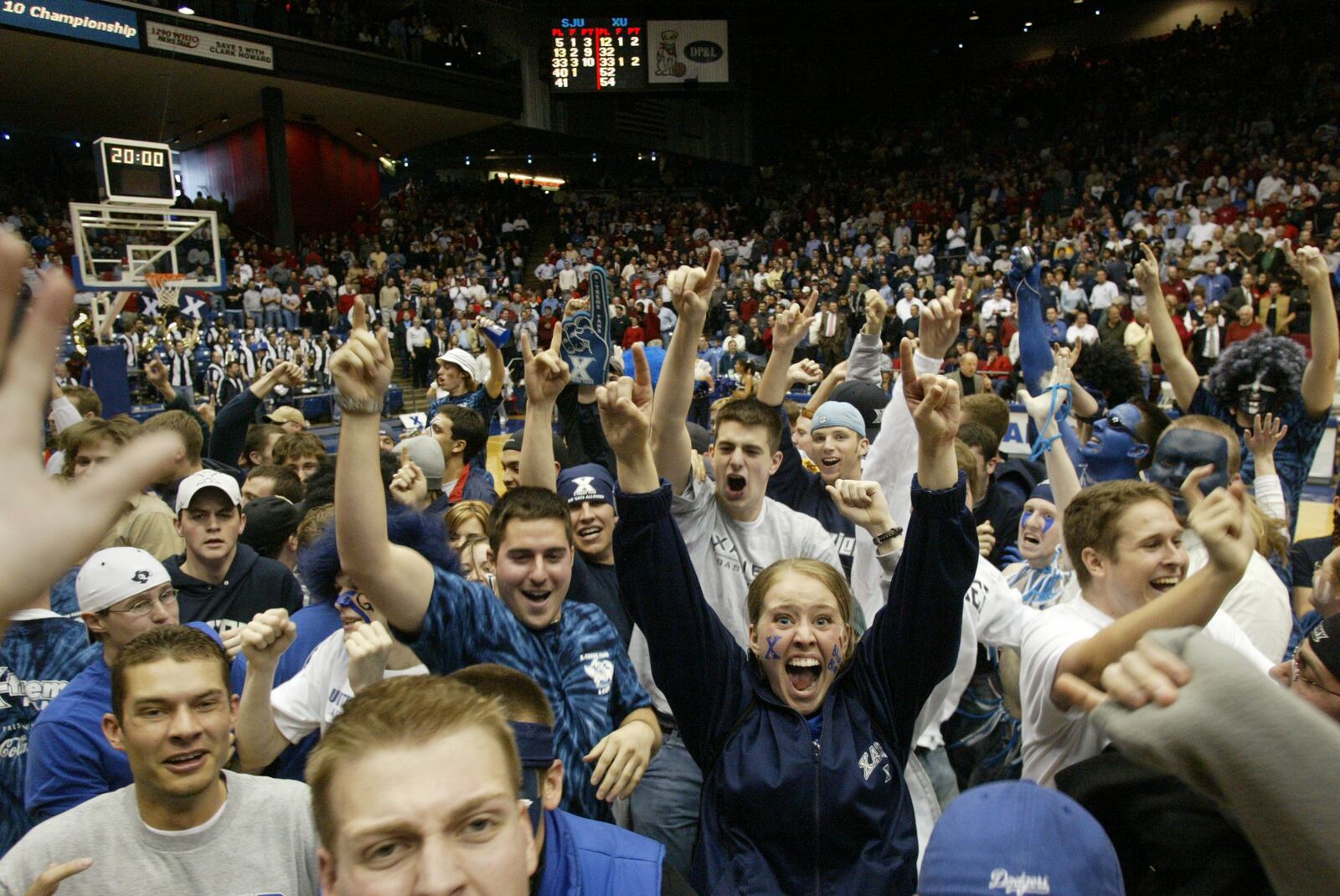 Xavier fans flood the court at the University of Dayton Arena Thursday afternoon after the Musketeers knocked off No. 1-ranked St. Joseph's, 87-67, during the Atlantic 10 Championship Tournament.