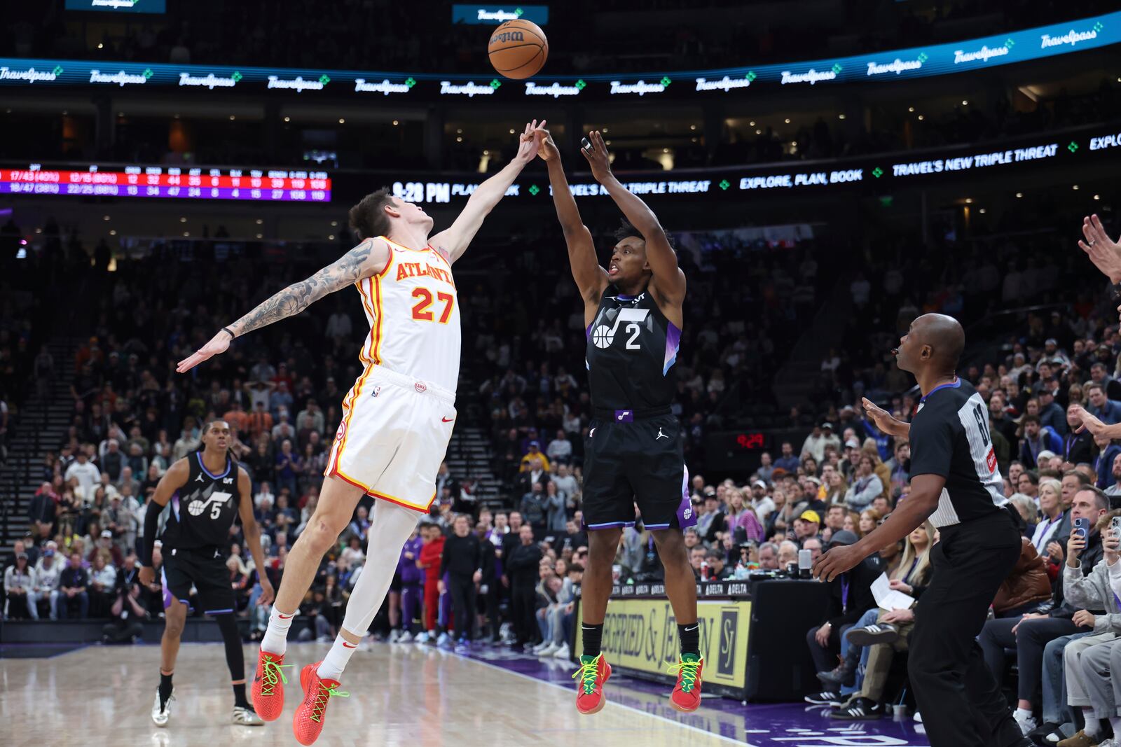 Utah Jazz guard Collin Sexton (2) shoots a three-point shot over Atlanta Hawks guard Vit Krejci (27) to tie the game with three seconds left in an NBA basketball game, Tuesday, Jan. 7, 2025, in Salt Lake City. (AP Photo/Rob Gray)