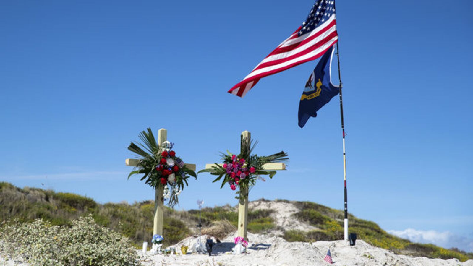 Adam Curtis Williams, 33, of Utah, is wanted in connection with the killings of a New Hampshire couple found buried on a Texas beach Sunday, Oct. 27, 2019. A makeshift memorial for James and Michelle Butler is seen on Padre Island Monday, Nov. 4.