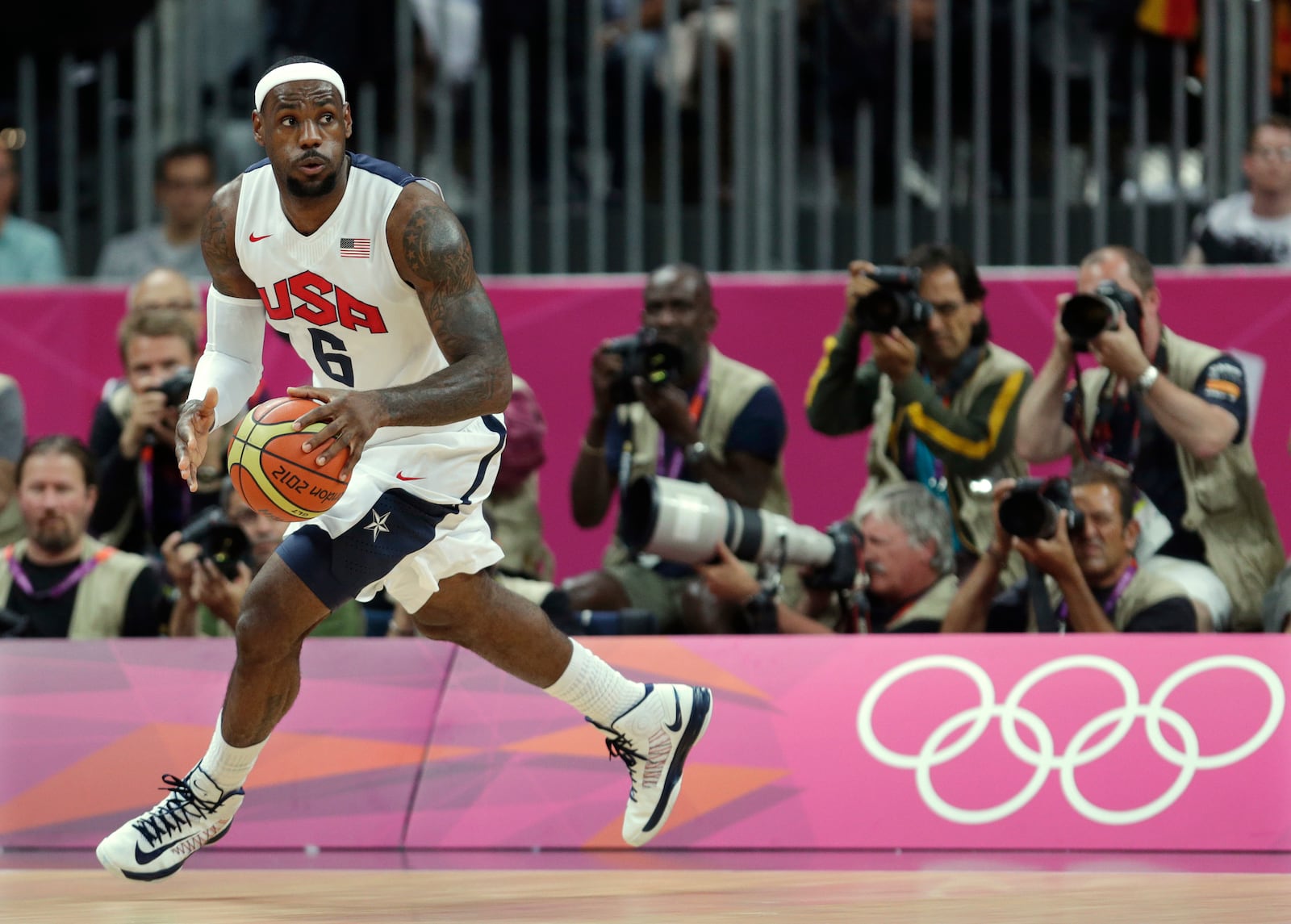 FILE - United States' Lebron James looks up the court during the first half of a preliminary men's basketball game against France at the 2012 Summer Olympics, on July 29, 2012, in London. (AP Photo/Charles Krupa, File)