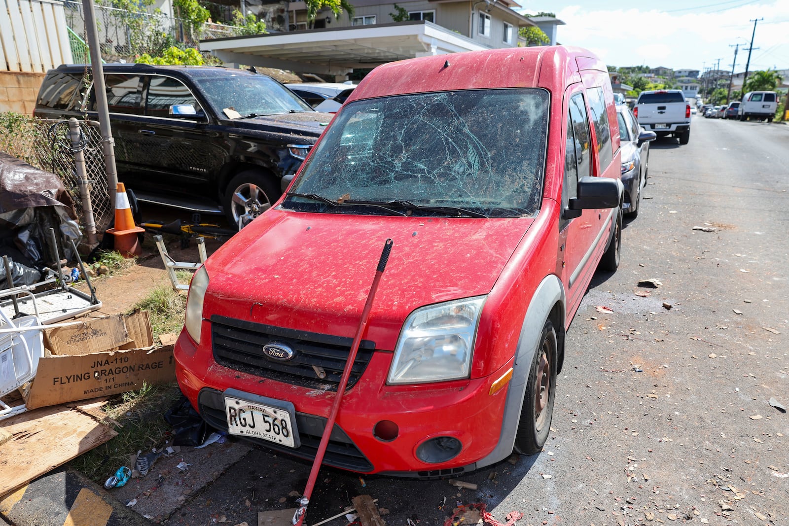 A damaged vehicle is seen near the home where a New Year's Eve fireworks explosion killed and injured people, Wednesday, Jan. 1, 2025, in Honolulu. (AP Photo/Marco Garcia)