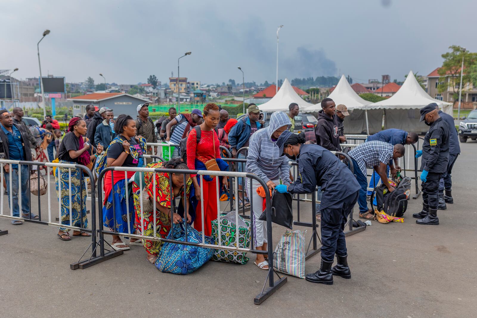 Rwanda security officials check people crossing from Congo in Gyseny, Rwanda, Tuesday, Jan. 28, 2025, following M23 rebels' advances into eastern Congo's capital Goma. (AP Photo/Yuhi Irakiza)