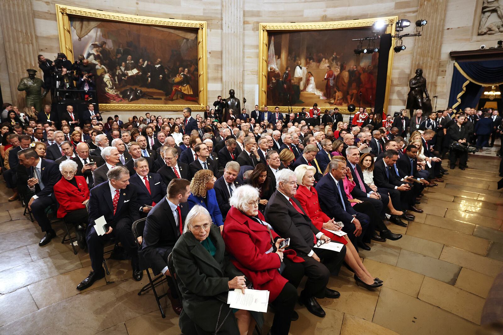 People sit before the 60th Presidential Inauguration in the Rotunda of the U.S. Capitol in Washington, Monday, Jan. 20, 2025. (Chip Somodevilla/Pool Photo via AP)