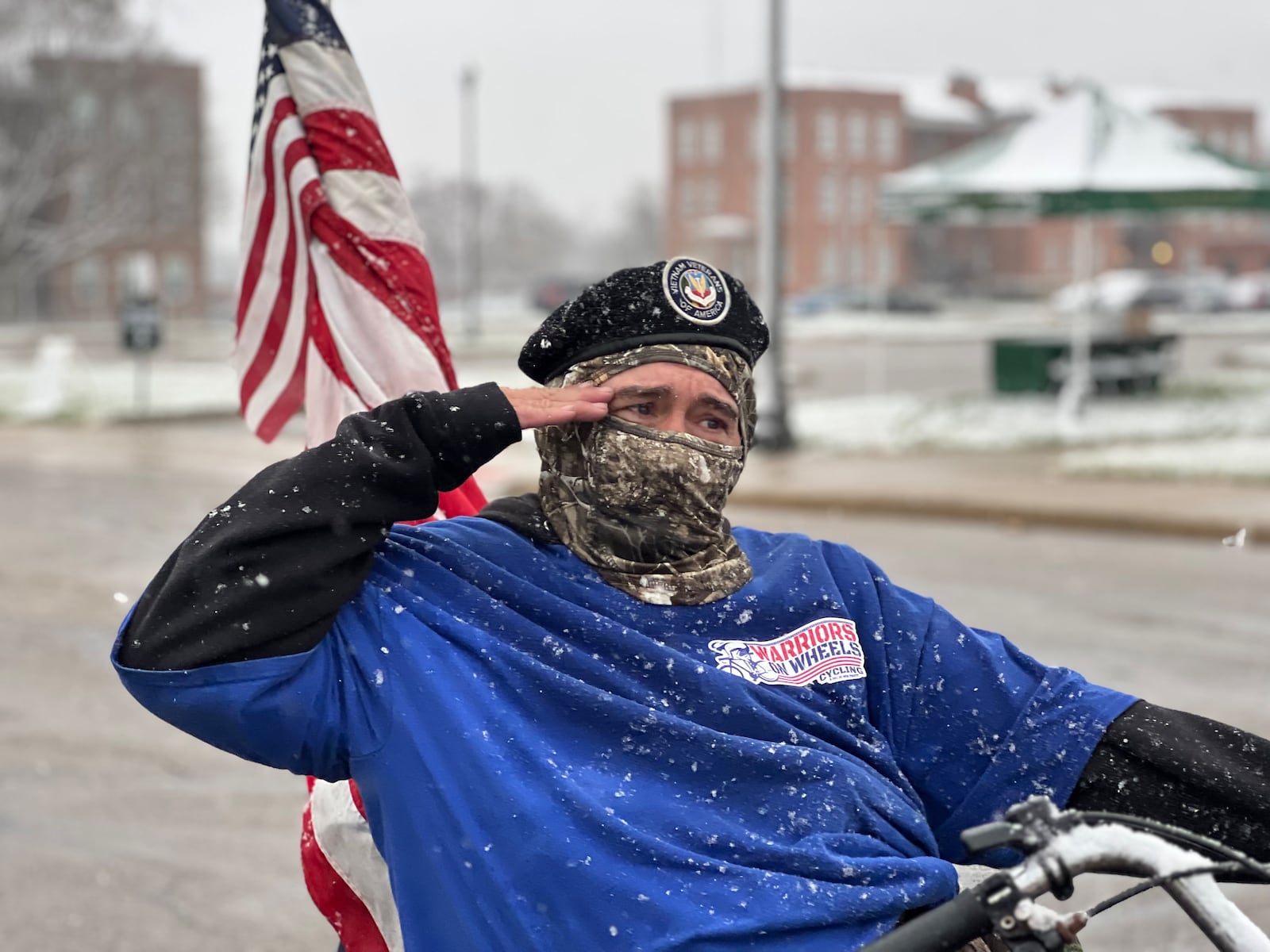 A veteran and parade participant salutes fellow vets in attendance during Saturday's event. AIMEE HANCOCK/STAFF