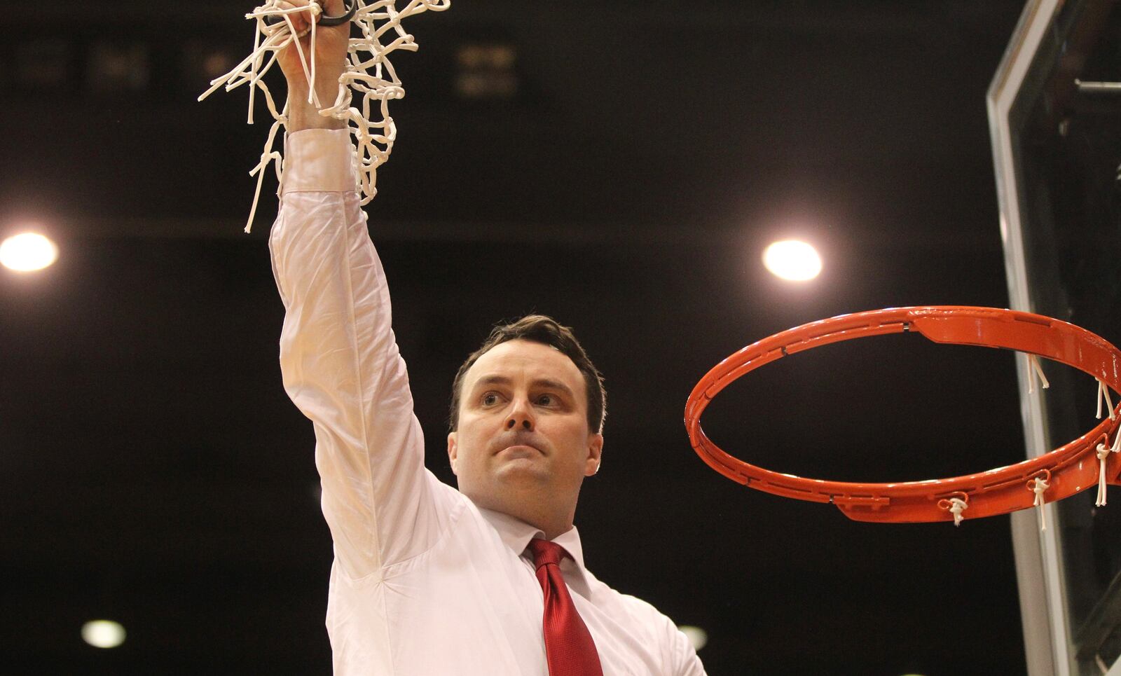 Dayton coach Archie Miller cuts down the net after clinching the A-10 championship with a victory against Virginia Commonwealth on Wednesday, March 1, 2017, at UD Arena.