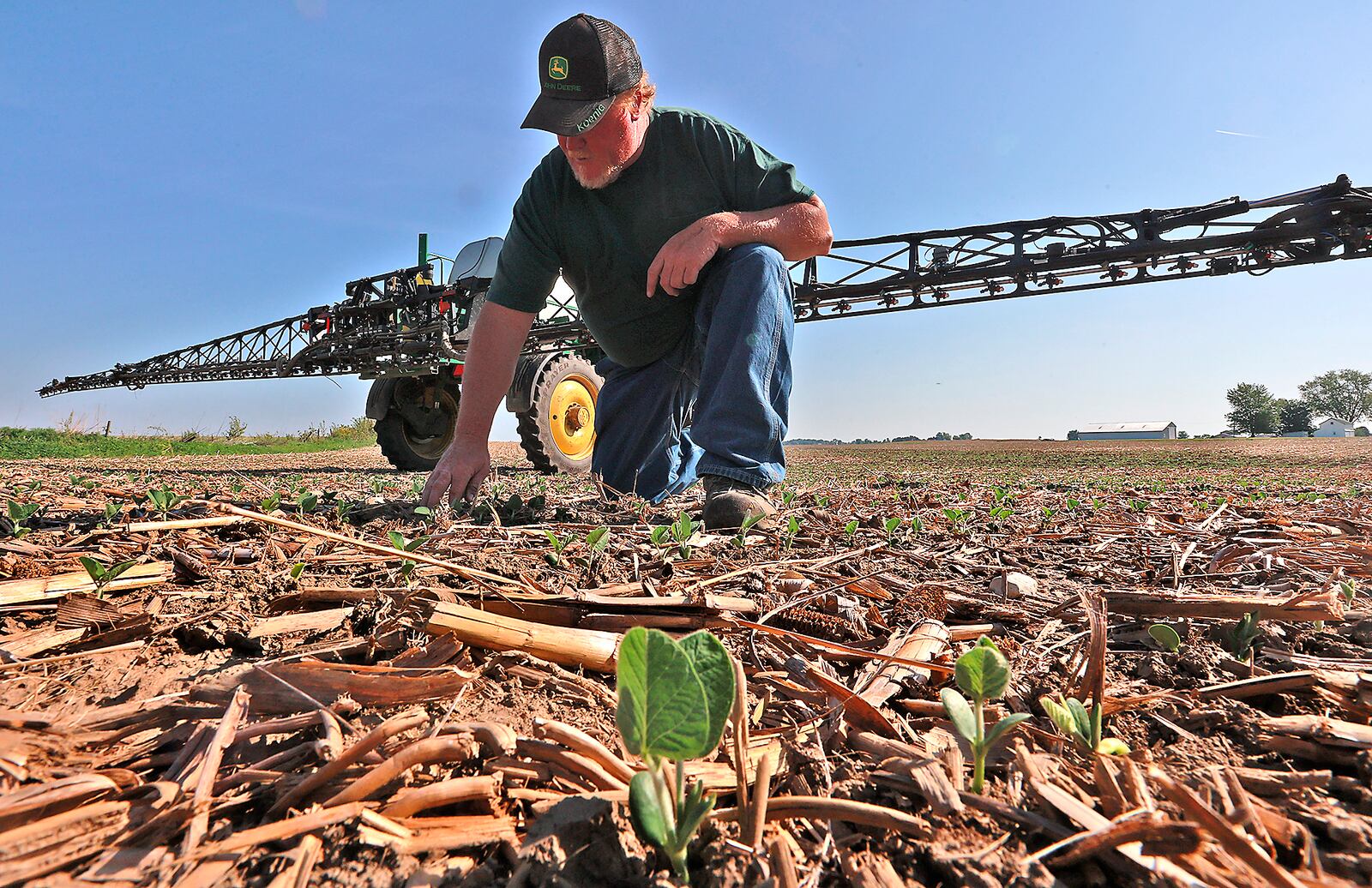 Clark County farmer Brian Harbage takes a break from spraying his bean field Friday, June 2, 2023 to check out how the plants are doing. BILL LACKEY/STAFF