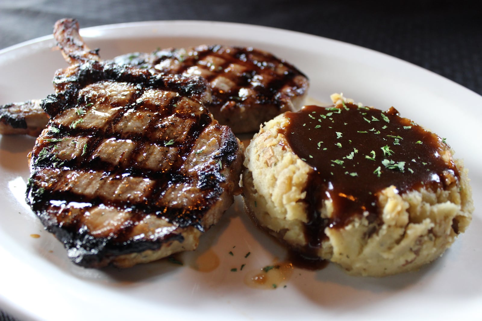 Two hand-cut pork chops marinated in Irish Whiskey served with mashed potatoes and Guinness gravy.  CONTRIBUTED