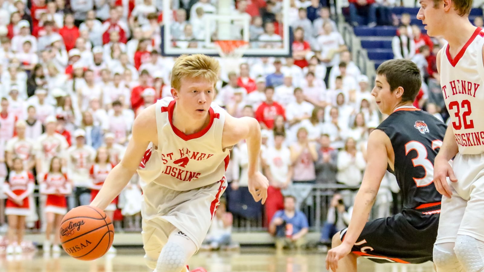 Andrew Lange of St. Henry drives against Trevor Sosby of Jackson Center during a Division IV regional final game at Fairmont Trent Arena. The Redskins won 46-43 advancing to the D-IV state tournament. CONTRIBUTED PHOTO BY MICHAEL COOPER