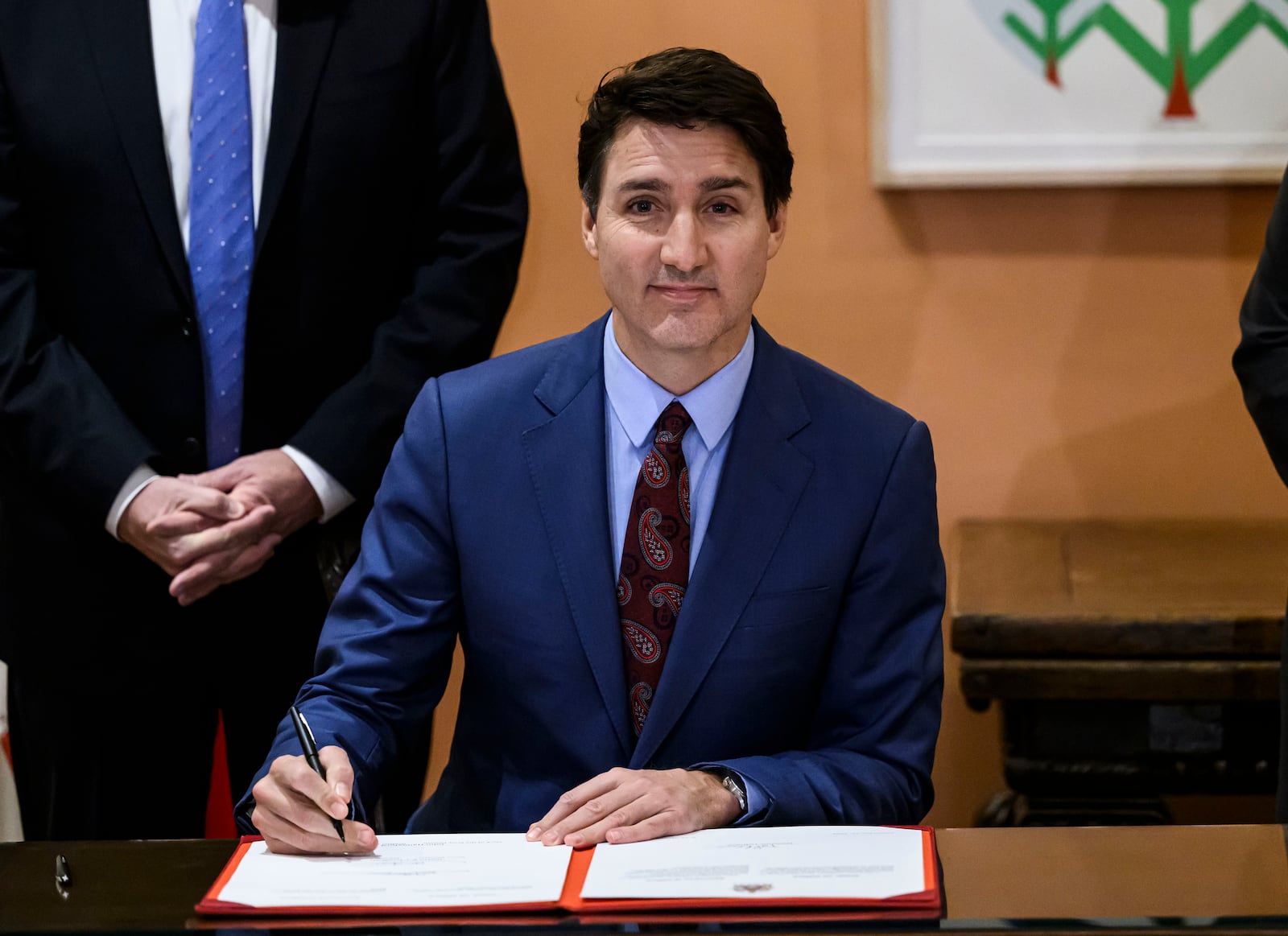 Canada's Prime Minister Justin Trudeau participates in a signing after Dominic LeBlanc, not shown, was sworn in as Finance Minister at a ceremony at Rideau Hall in Ottawa, Ontario, Monday, Dec. 16, 2024. (Justin Tang/The Canadian Press via AP)