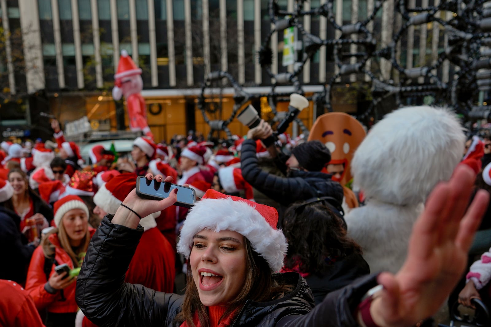 Revellers take part in SantaCon, Saturday, Dec. 14, 2024, in New York. (AP Photo/Julia Demaree Nikhinson)