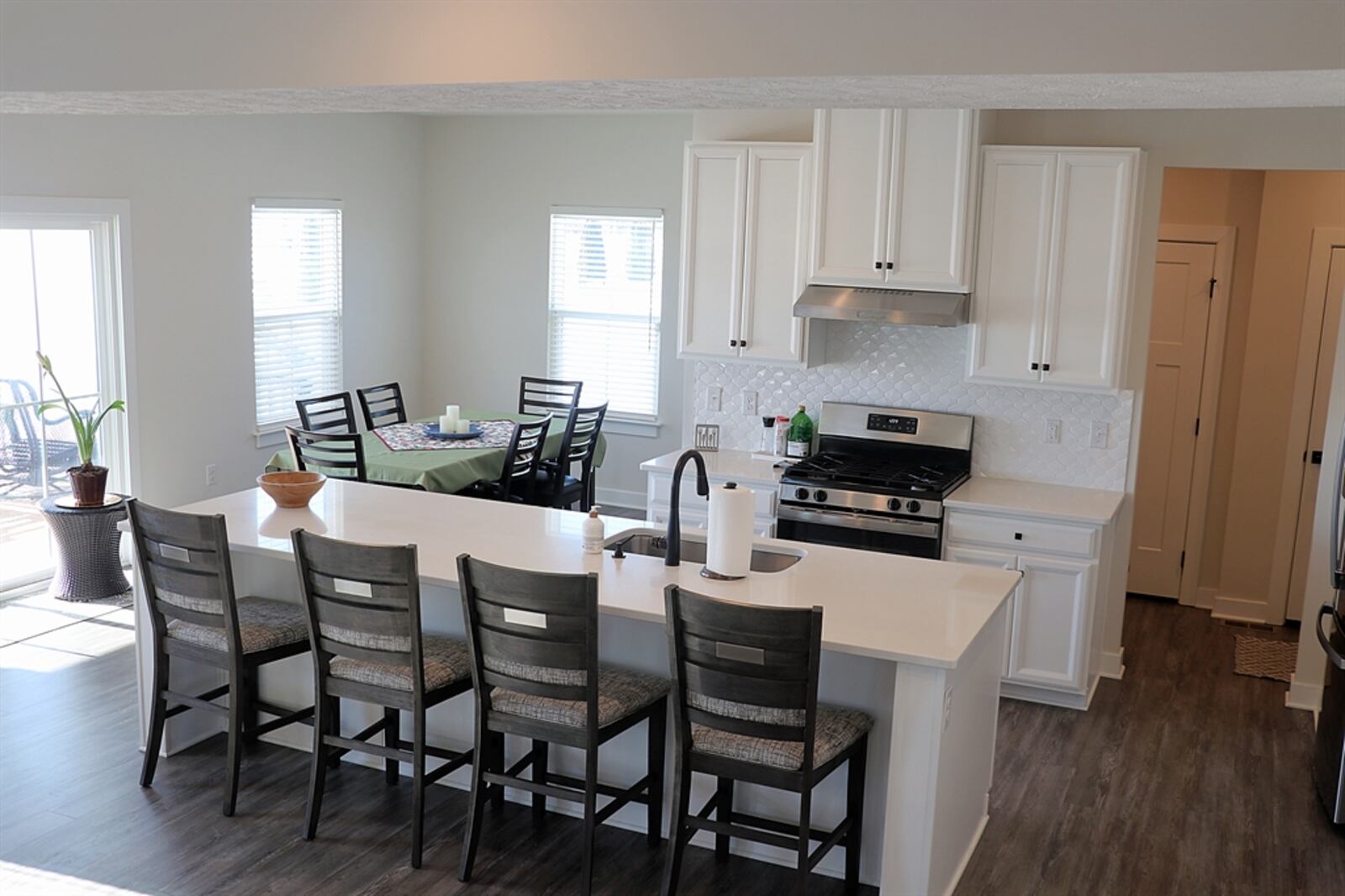 A large island with an extended granite counter allows for breakfast bar seating for up to four. On the kitchen side, the island has a sink, dishwasher and storage. CONTRIBUTED BY KATHY TYLER