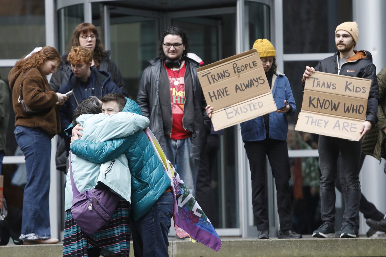 People celebrate outside a Seattle federal courthouse after a second federal judge paused President Donald Trump's order against gender-affirming care for youth on Friday, Feb. 14, 2025 in Seattle.. (AP Photo/Manuel Valdes)