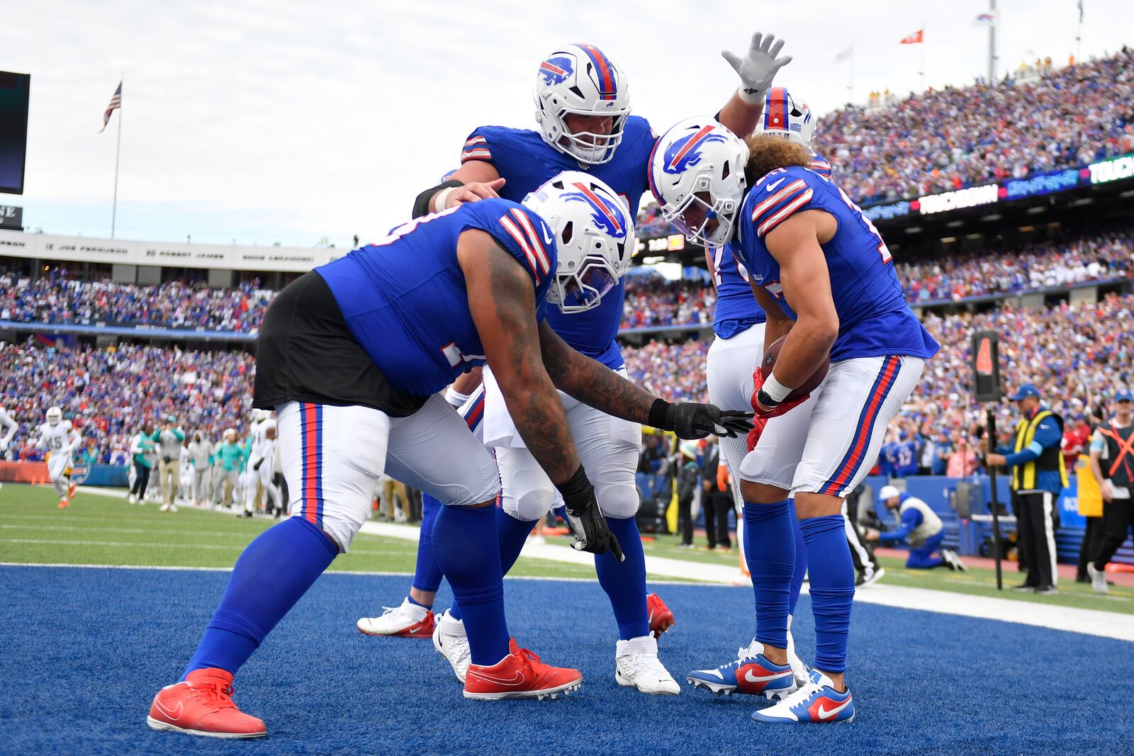 Buffalo Bills wide receiver Mack Hollins, right, celebrates with offensive tackle Dion Dawkins, left, and offensive tackle Spencer Brown, center, after scoring a touchdown during the second half of an NFL football game against the Miami Dolphins, Sunday, Nov. 3, 2024, in Orchard Park, N.Y. (AP Photo/Adrian Kraus)