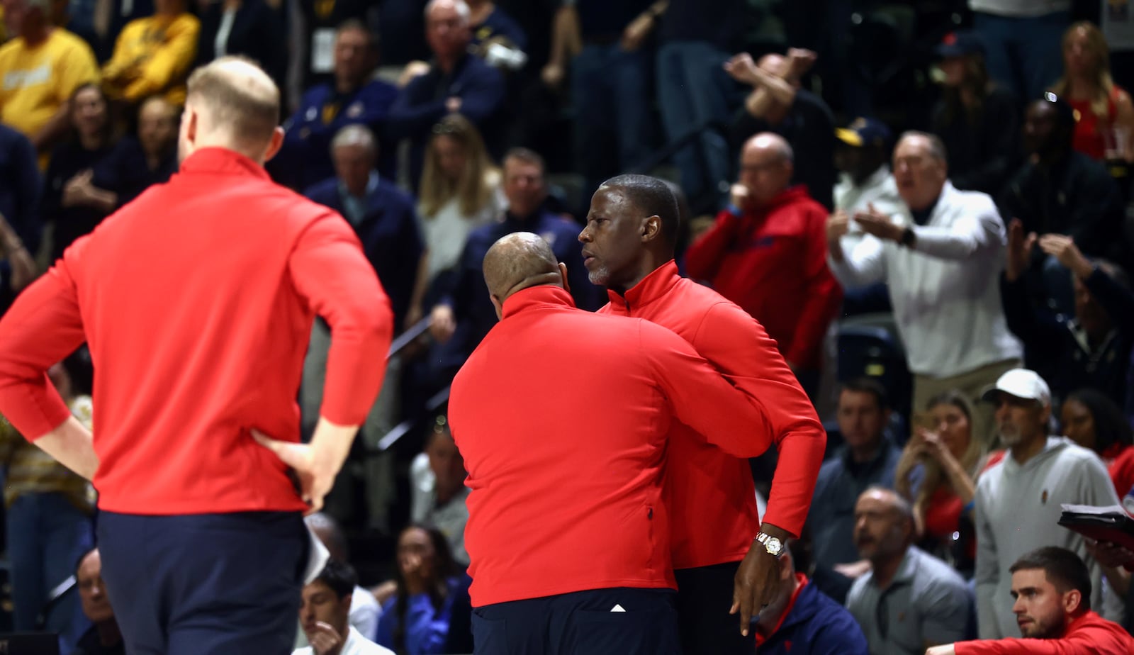 Dayton's Jermaine Henderson holds back Anthony Grant as Grant argues with an official in the second half against Chattanooga in the second round of the National Invitation Tournament on Saturday, March 22, 2025, at McKenzie Arena in Chattanooga, Tenn. David Jablonski/Staff