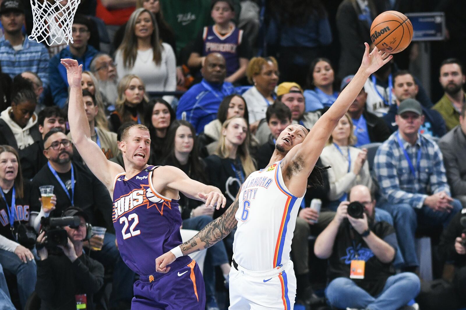 Oklahoma City Thunder forward Jaylin Williams (6) tips the ball away from Phoenix Suns center Mason Plumlee (22) during the first half of an NBA basketball game, Wednesday, Feb. 5, 2025, in Oklahoma City. (AP Photo/Kyle Phillips)