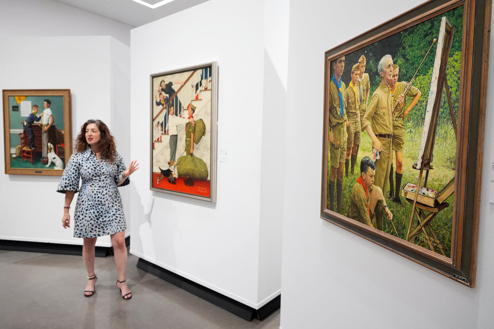 Aviva Lehmann, Heritage Auction's senior vice president of American art, responds to a question as she stands by paintings in Dallas, Thursday, Oct. 17, 2024, that are some of many works from the Boy Scouts of America's art collection — including some paintings by Norman Rockwell — that will go up for auction this month to help compensate tens of thousands of people, mainly men, who were sexually abused while in scouting. (AP Photo/Tony Gutierrez)