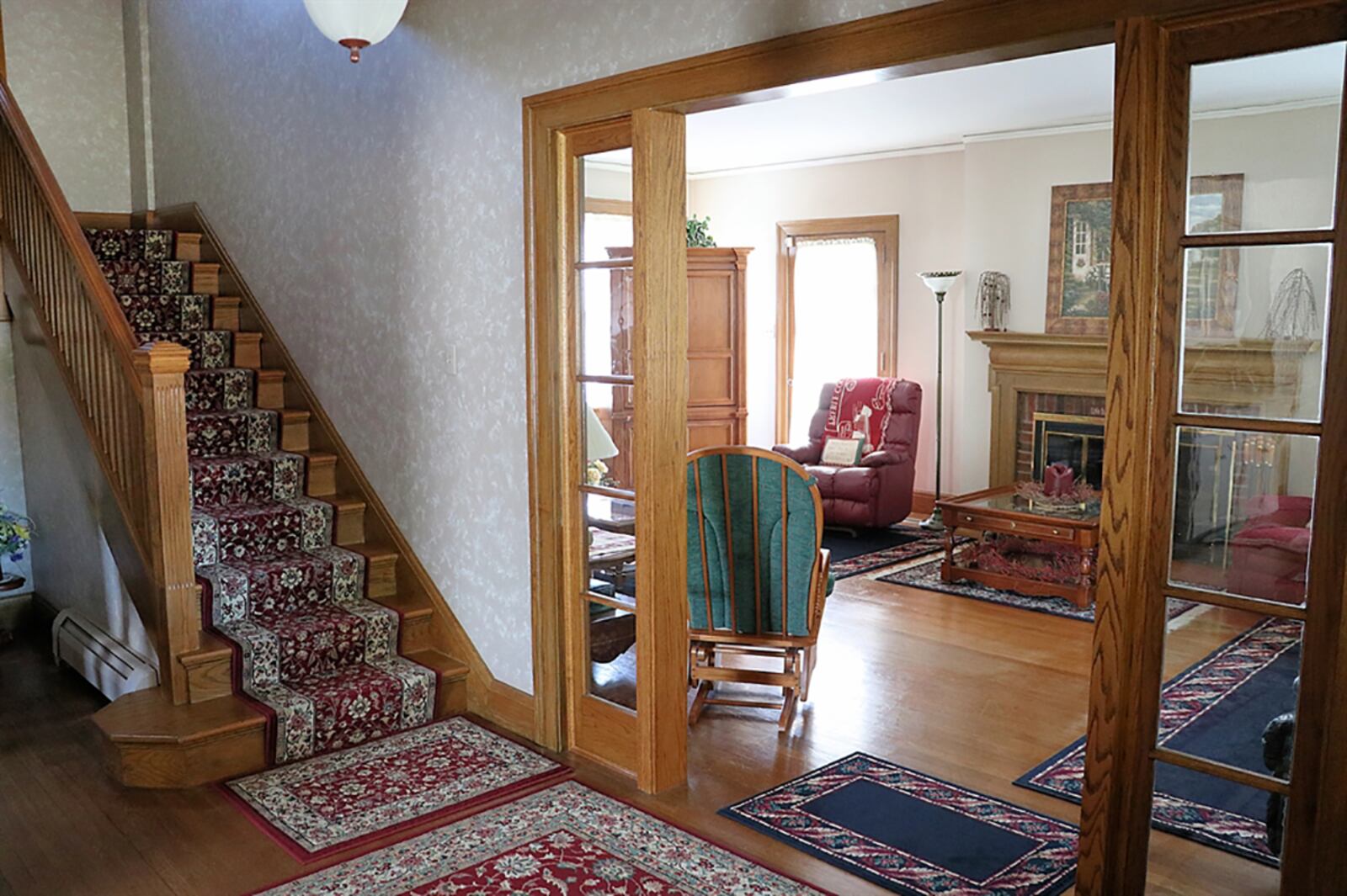 French doors open from the foyer into the dining room, which has the original chandelier and a bow window. A built-in china cabinet has a buffet counter with a pass-through into the kitchen. CONTRIBUTED PHOTO BY KATHY TYLER