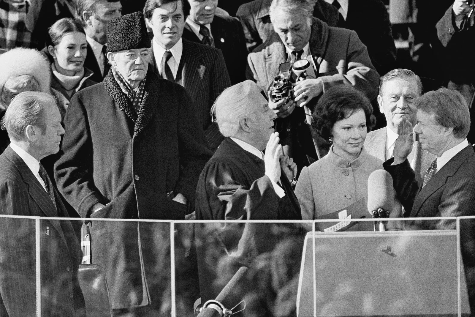 FILE - Jimmy Carter takes the oath of office as the 39th president of the United States at the Capitol in Washington, Jan. 20, 1977, as his wife Rosalynn holds the Bible. Chief Justice of the United States Warren Burger administers the oath while Sen. Howard Cannon of Nevada stands behind the Carters. (AP Photo, File)