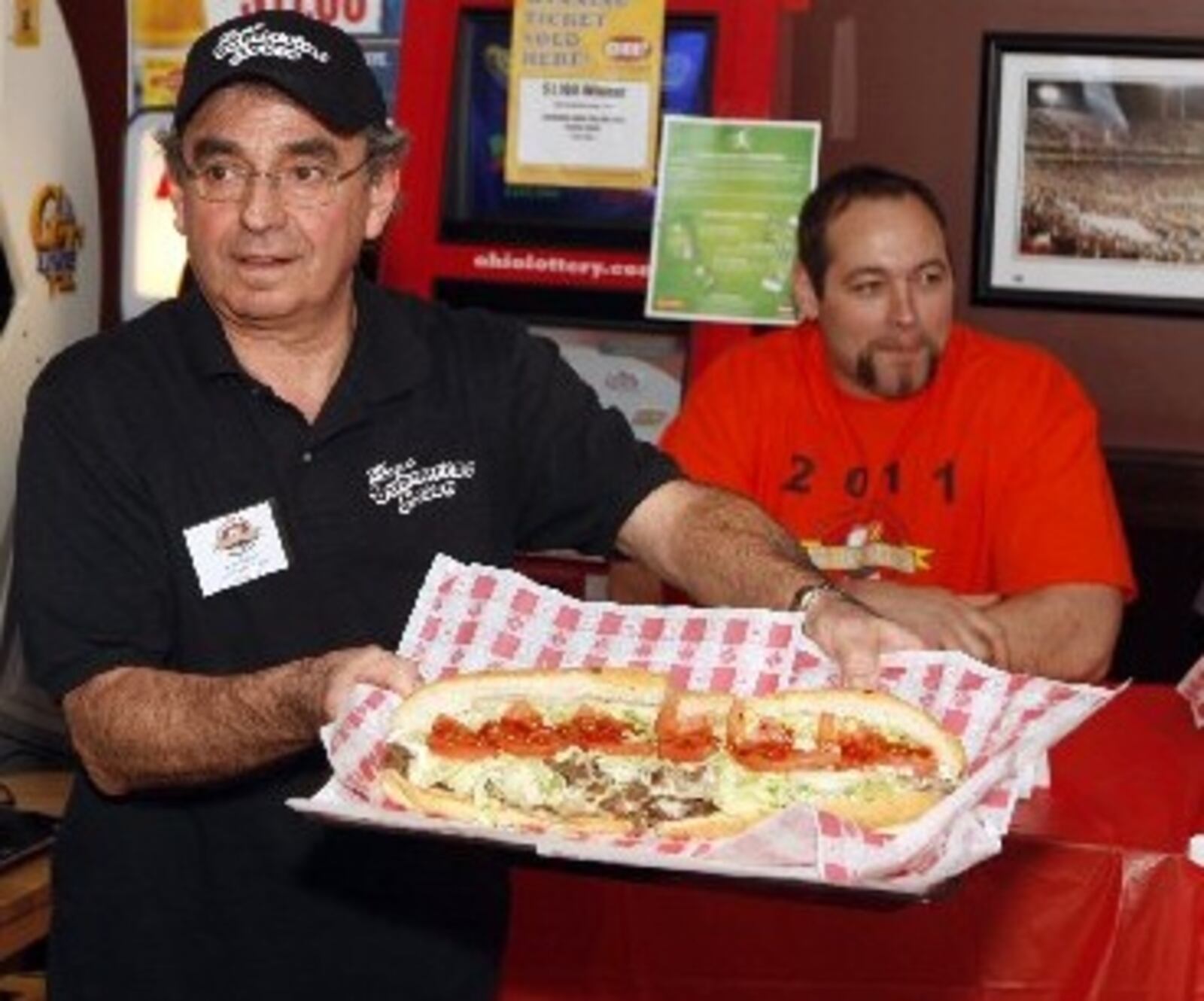 In this archived photo, Gary Danner from the Submarine House shows the 16-inch Super Duper Cheesesteak that six contestants raced to consume in the 2011 Miami Valley Cheesesteak Challenge. (Staff photo by Jan Underwood.