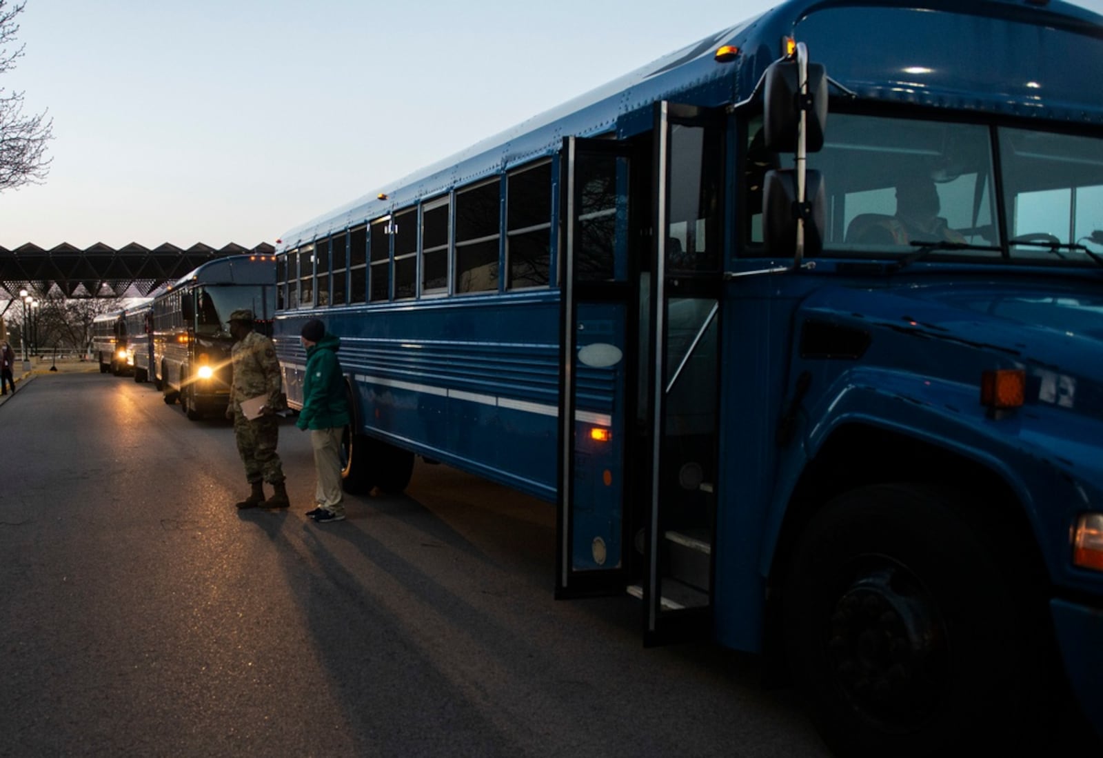 In this photo from March 2021, buses loaded with deployers await departure from the 88th Medical Group at Wright-Patterson Air Force Base in support of the Federal Emergency Management whole-of-government COVID response.  (U.S. Air Force photo by Wesley Farnsworth)