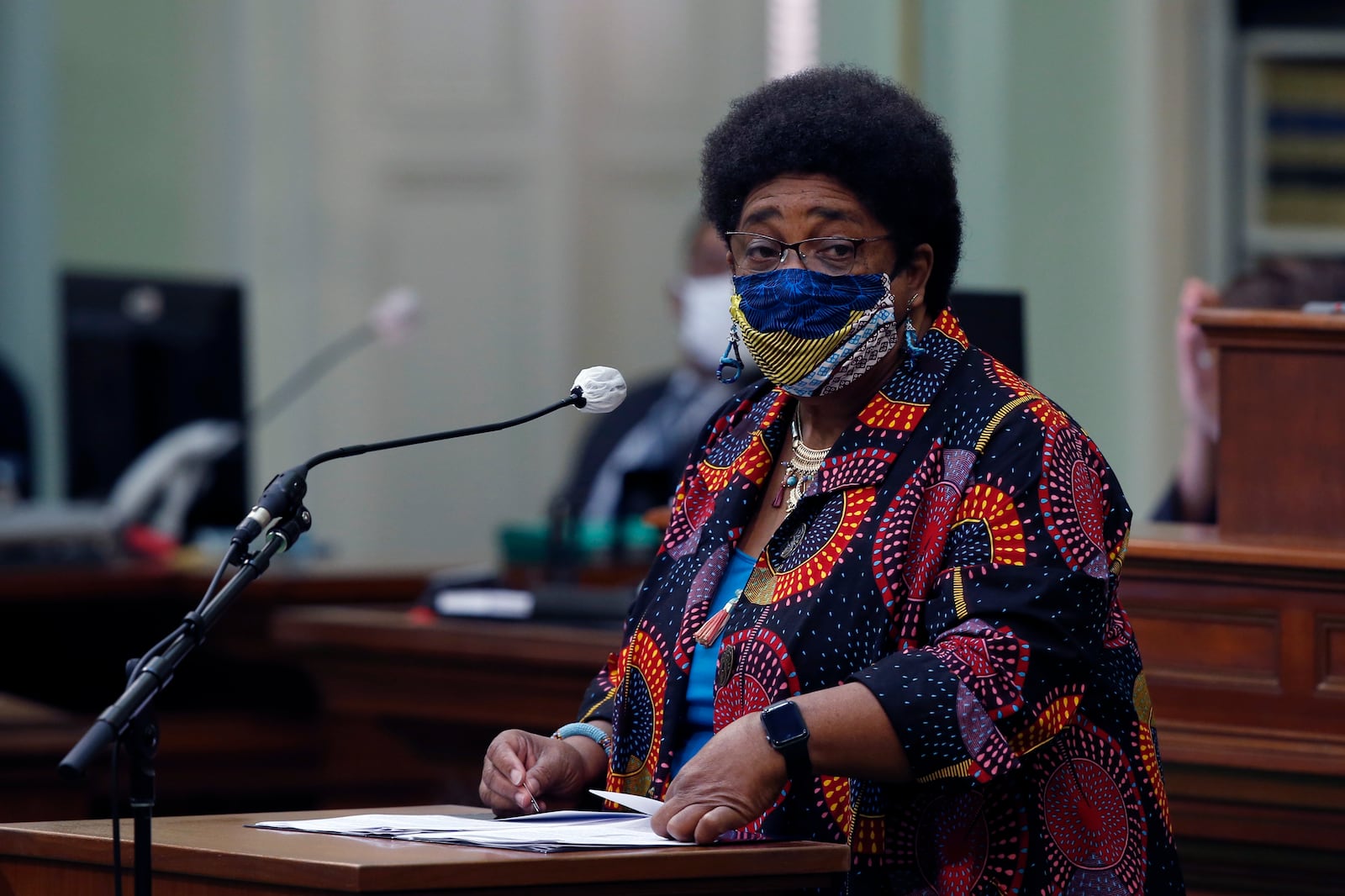 FILE - In this June 11, 2020, file photo, Assemblywoman Shirley Weber, D-San Diego, wears a face mask as she calls on lawmakers to create a task force to study and develop reparation proposals for African Americans, during the Assembly session in Sacramento, Calif. California lawmakers are setting up a task force to study and make recommendations for reparations to African-Americans, particularly the descendants of slaves, as the nation struggles again with civil rights and unrest following the latest shooting of a Black man by police. The state Senate supported creating the nine-member commission on a bipartisan 33-3 vote Saturday, Aug. 29, 2020. (AP Photo/Rich Pedroncelli, File)