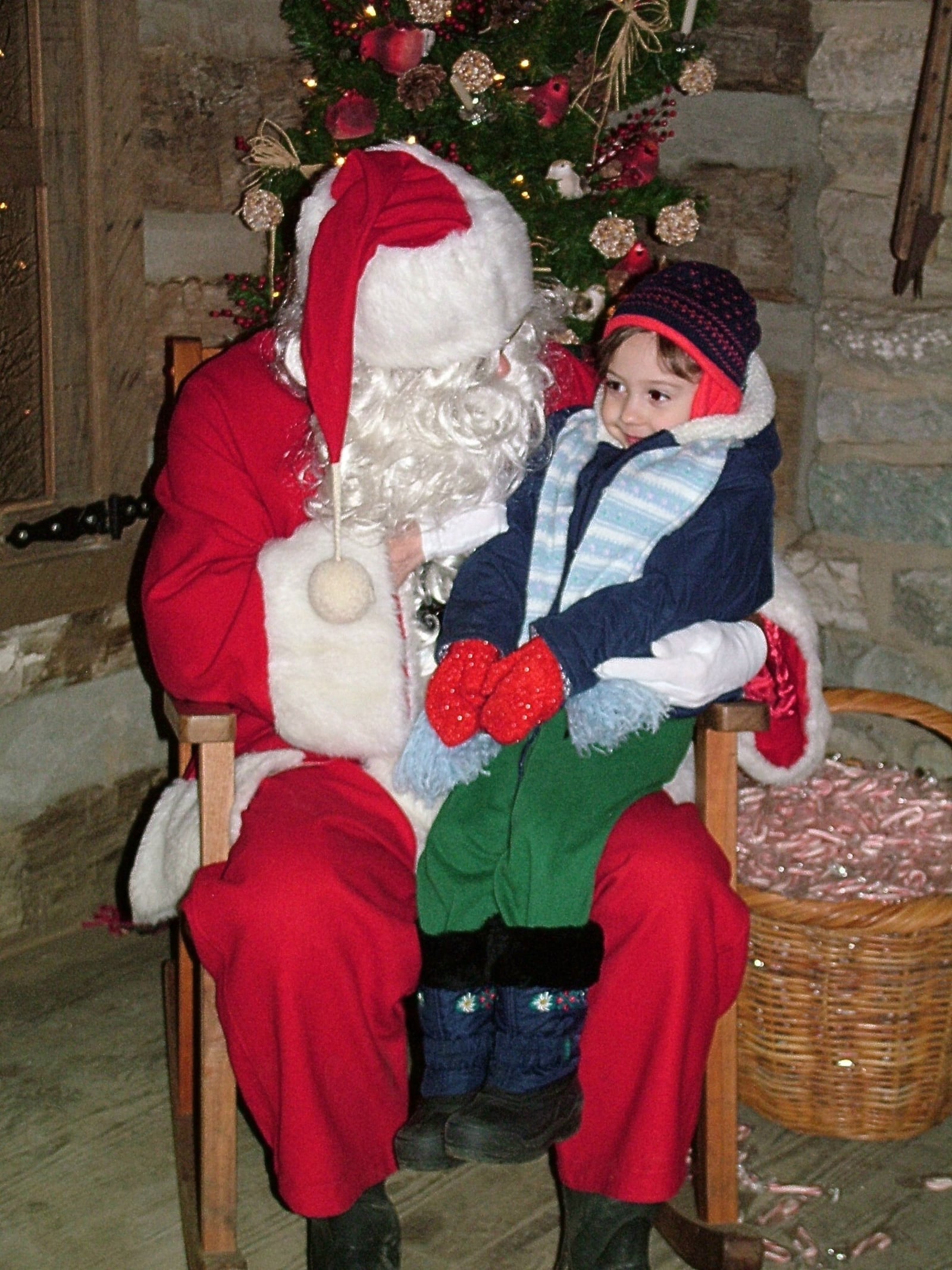 A small child talks to Santa Claus during a past Woodland Lights in Washington Twp.