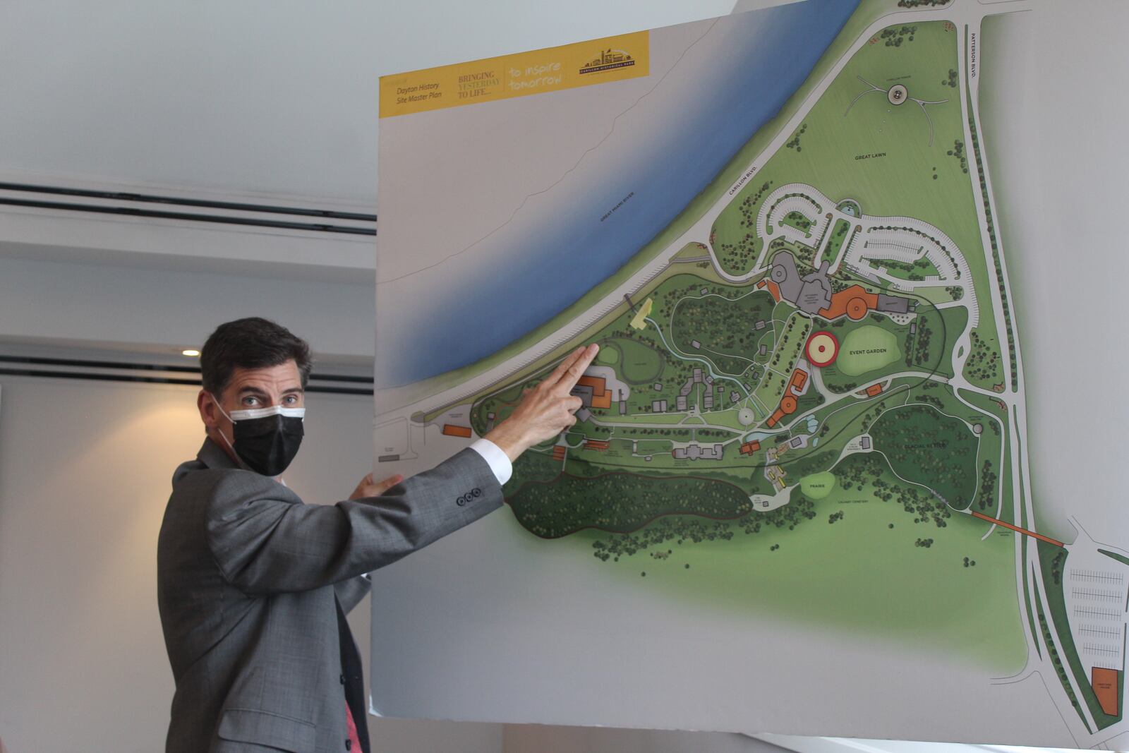 Brady Kress, president and CEO of Dayton History, points out the rail line on a map of the 65-acre Carillon Historical Park. CORNELIUS FROLIK / STAFF