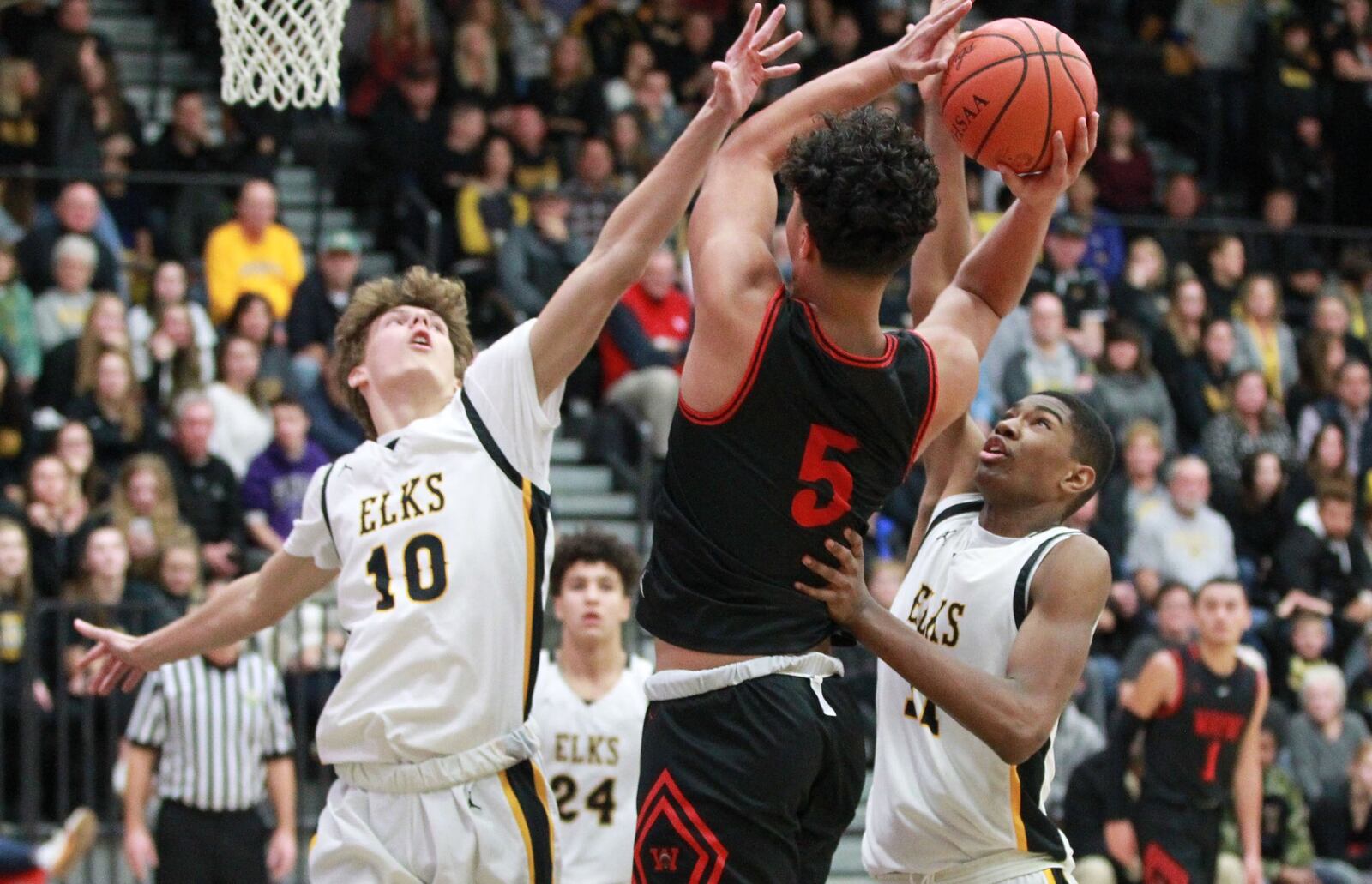 Elijah Brown of Wayne (shooting) draws Centerville defenders Ryan Keifer (left) and Kebba Njie. Wayne defeated host Centerville 52-50 in a GWOC boys high school basketball game on Friday, Dec. 13, 2019. MARC PENDLETON / STAFF