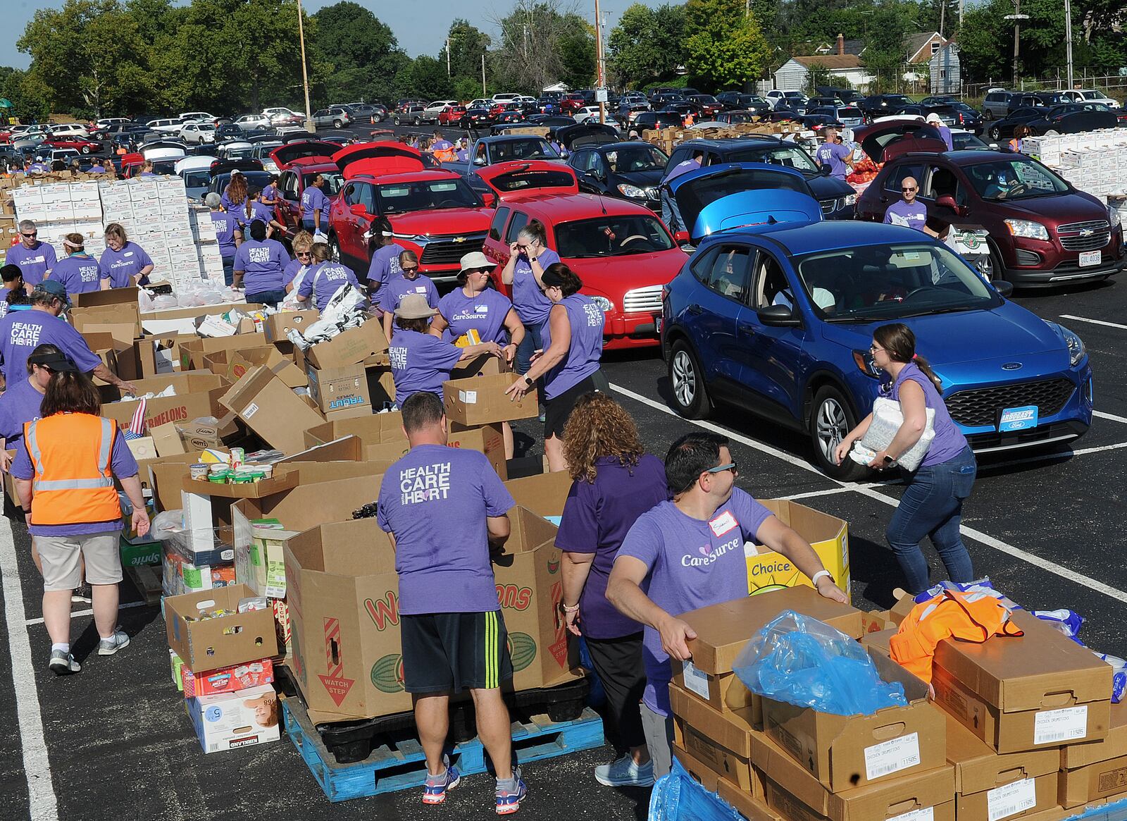 The Dayton Foodbank, Inc. along with nearly 200 volunteers from CareSource served over 1,000 families at the University of Dayton Arena Mass food distribution Tuesday Aug. 23, 2022. MARSHALL GORBY\STAFF