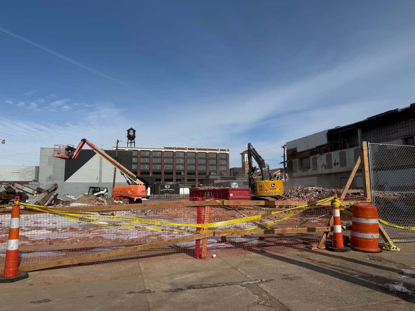 Two buildings on the 400 block of East Third Street in downtown Dayton that once belonged to KK Motorcycle Supply have been torn down. Site plans indicate the properties will become a new parking lot. A building on the same block is supposed to become new offices. CORNELIUS FROLIK / STAFF