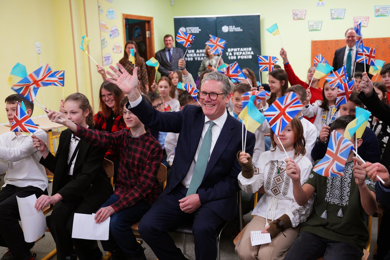 British Prime Minister Keir Starmer waves as he sits with school children as they communicate over video link with a British primary school in Kyiv, Ukraine, Thursday, Jan. 16, 2025 (Carl Court, Pool Photo via AP)