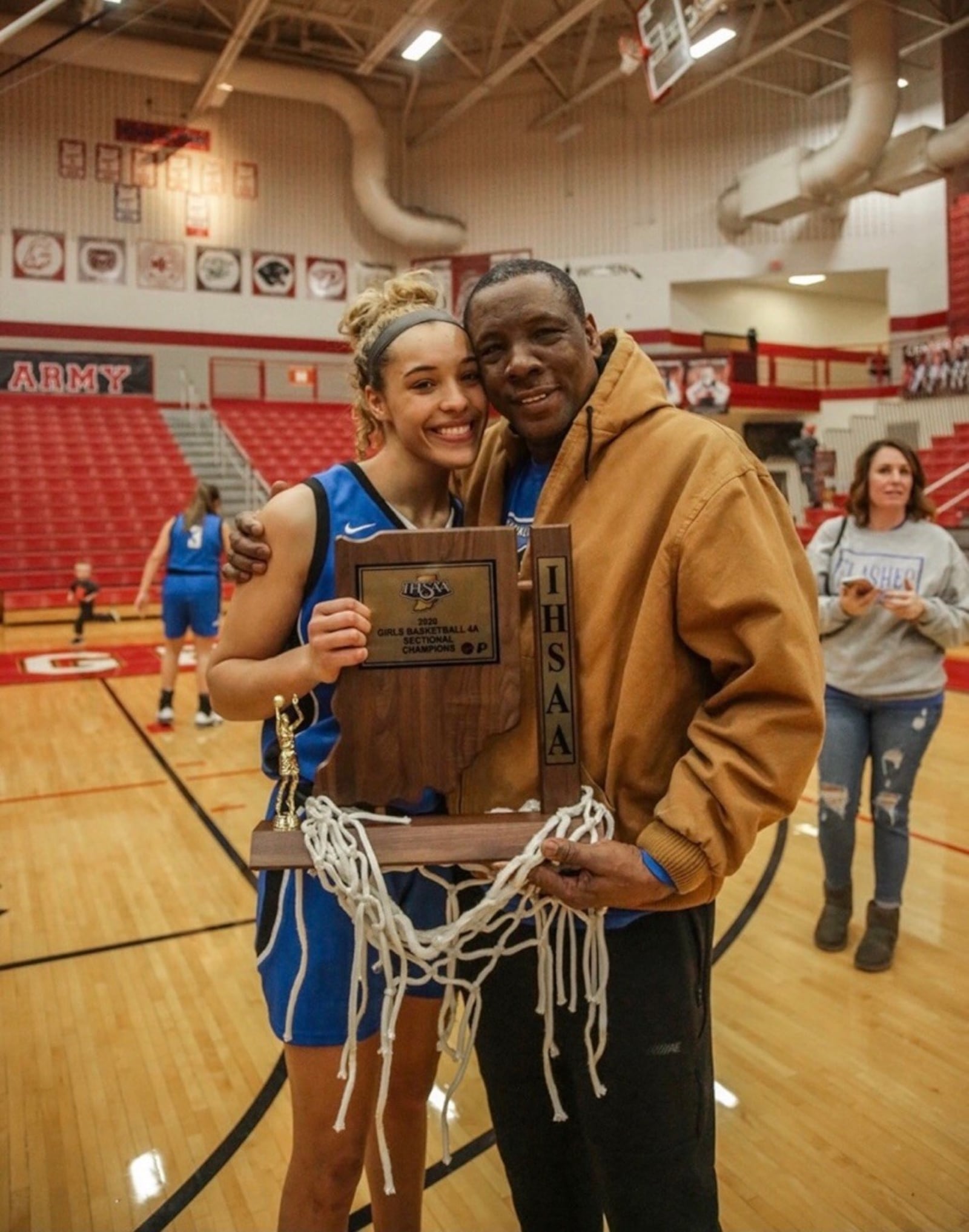 Patrick Loobie gives his daughter Rachel, the star of the Franklin Central High in Indianapolis, a hug after the Flashes won the 4A  Sectional Tournament in 2020. Rachel scored 1,396 points in high school and pulled down a school record 773 rebounds. CONTRIBUTED