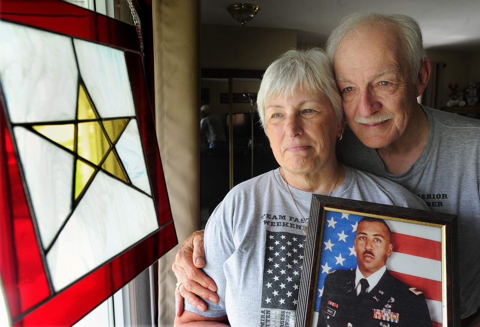 Jim and Leslie Groves embrace a photo of their son, US Army Chief Warrant Officer James E. Groves III. Groves was killed in Afghanistan in 2013 when he was 37, He was assigned to 3rd Squadron, 17th Cavalry Regiment, 3rd Combat Aviation Brigade, 3rd Infantry Division Hunter Army Airfield, Ga.; died March 16 in Kandahar, Afghanistan, in an OH-58 Kiowa helicopter crash.. MARSHALL GORBY\STAFF